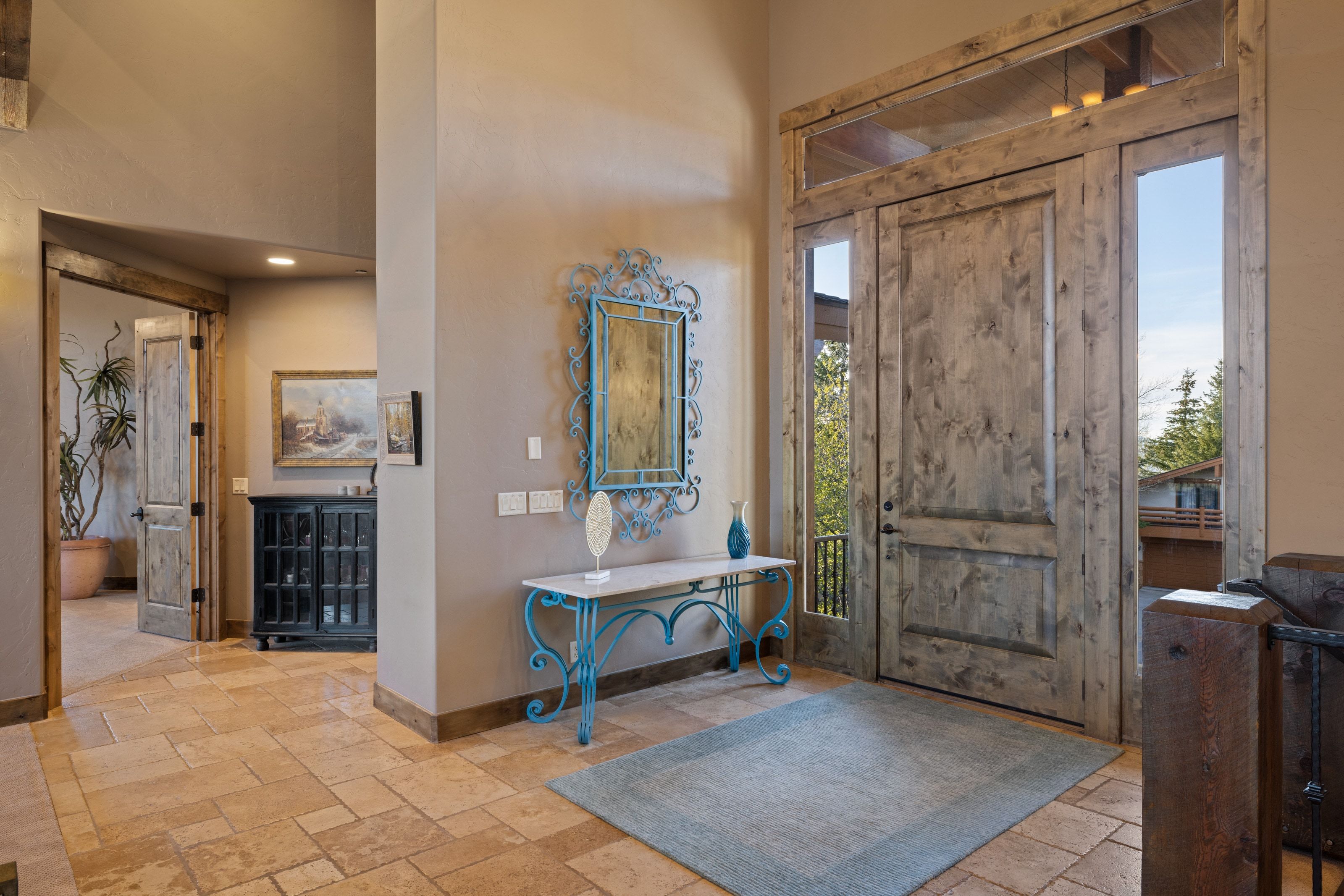 Foyer with stone tile flooring and a high ceiling
