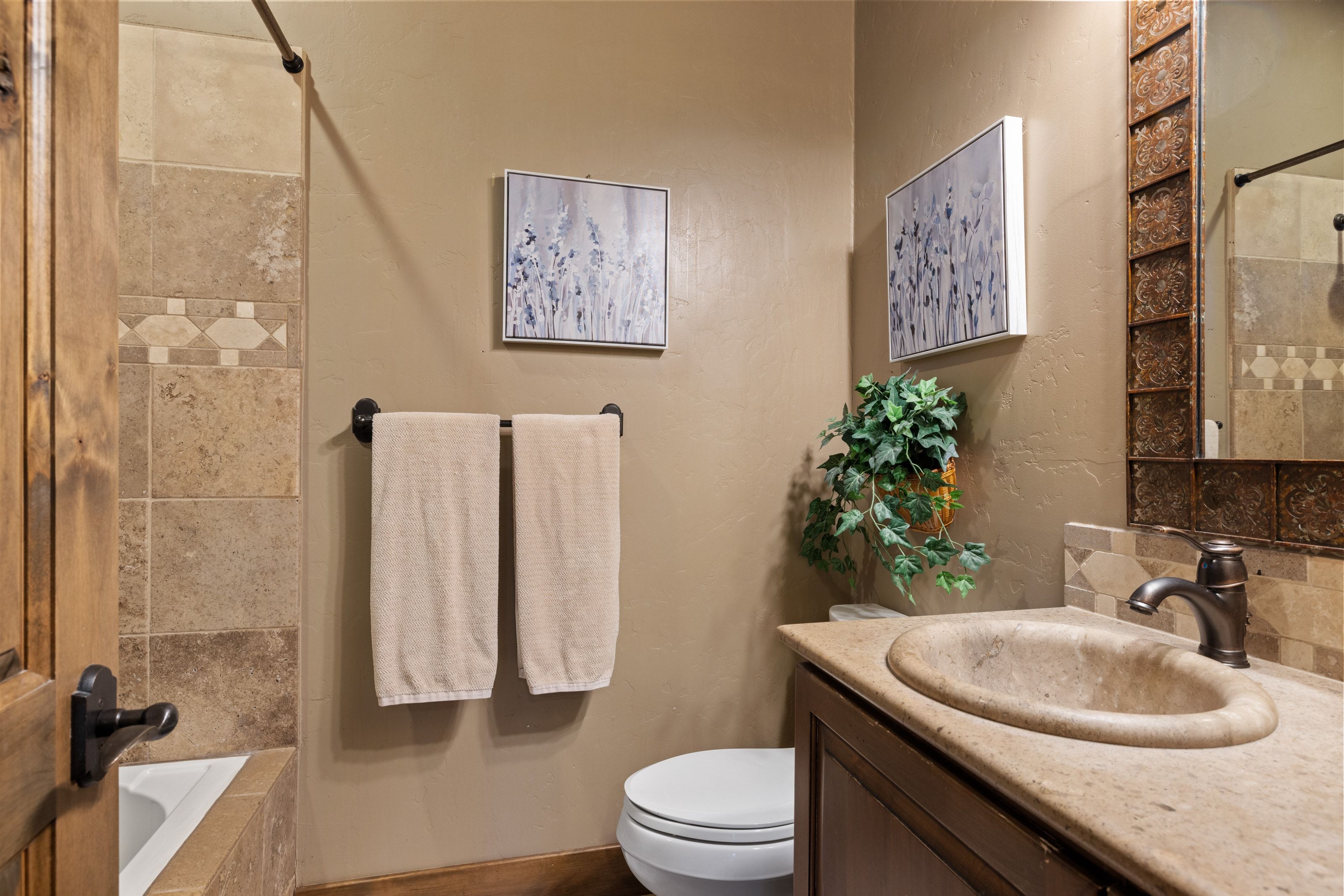 Bathroom with vanity and tiled shower / bath combo