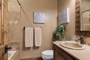 Bathroom with vanity and tiled shower / bath combo