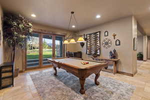 Recreation room featuring stone tile floors, billiards table, and recessed lighting