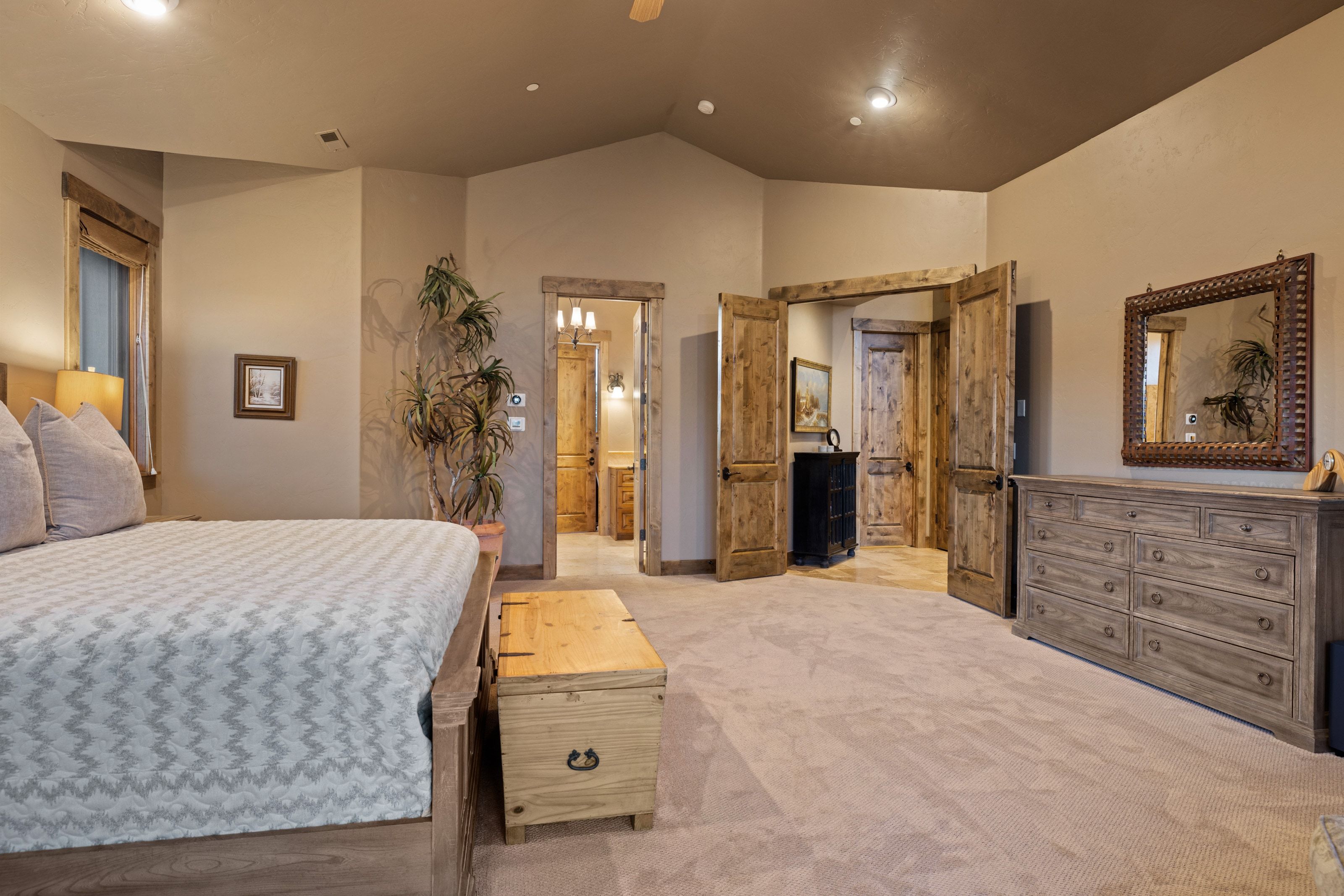 Bedroom with lofted ceiling, light carpet, a ceiling fan, and recessed lighting