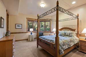 Carpeted bedroom featuring baseboards