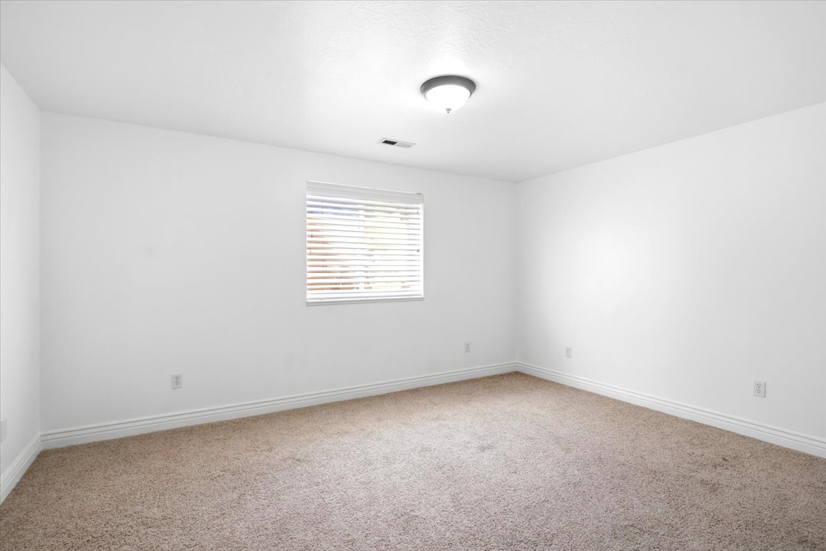 Neutral-toned carpeting paired with white baseboards and walls