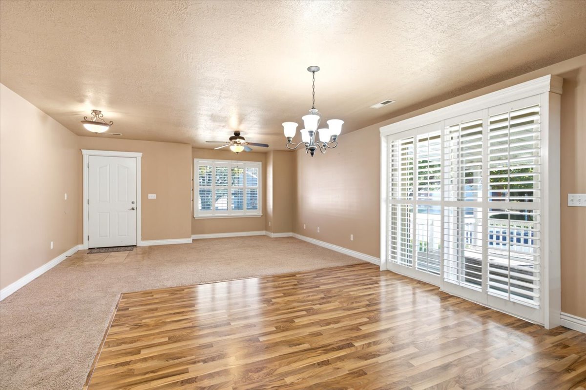 Interior space featuring wood-finish flooring, carpeted area, and neutral wall tones
