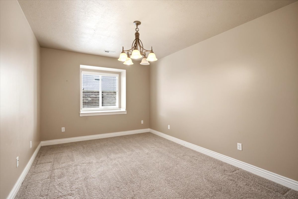 Neutral tone walls with white trim and a textured ceiling