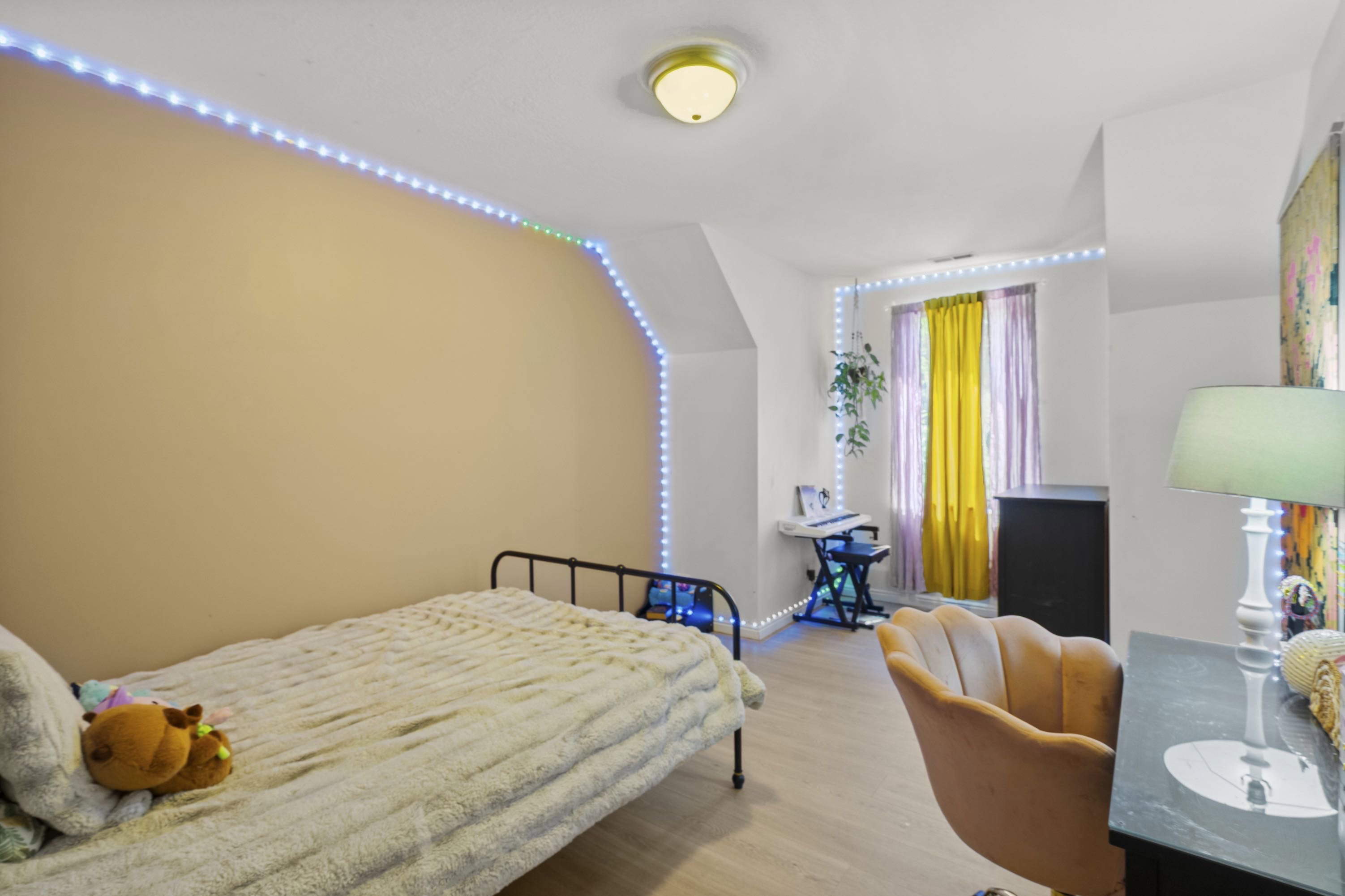Light-toned wood-finish flooring complements the neutral wall color in this room