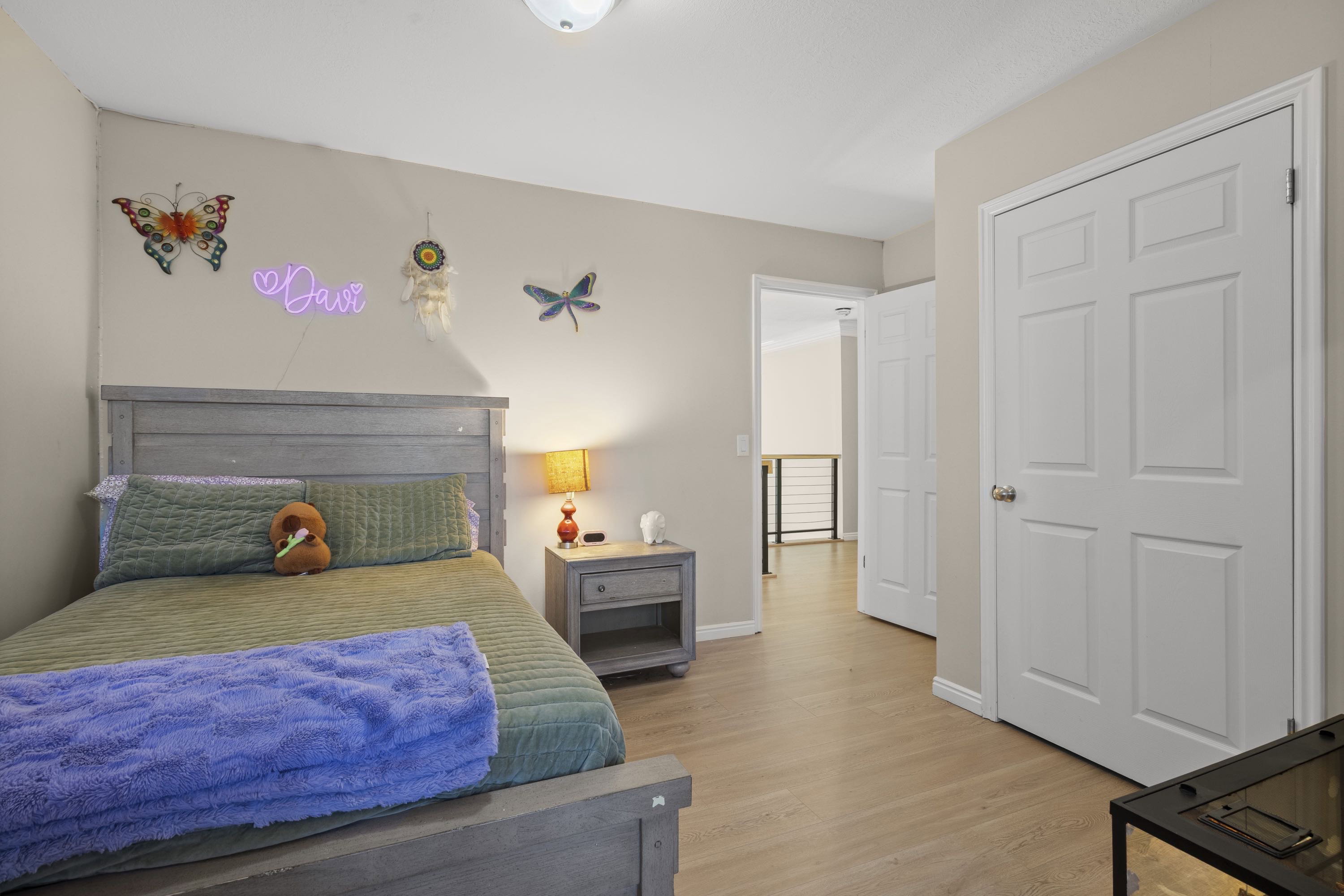Bedroom featuring wood-finish flooring and neutral wall tones