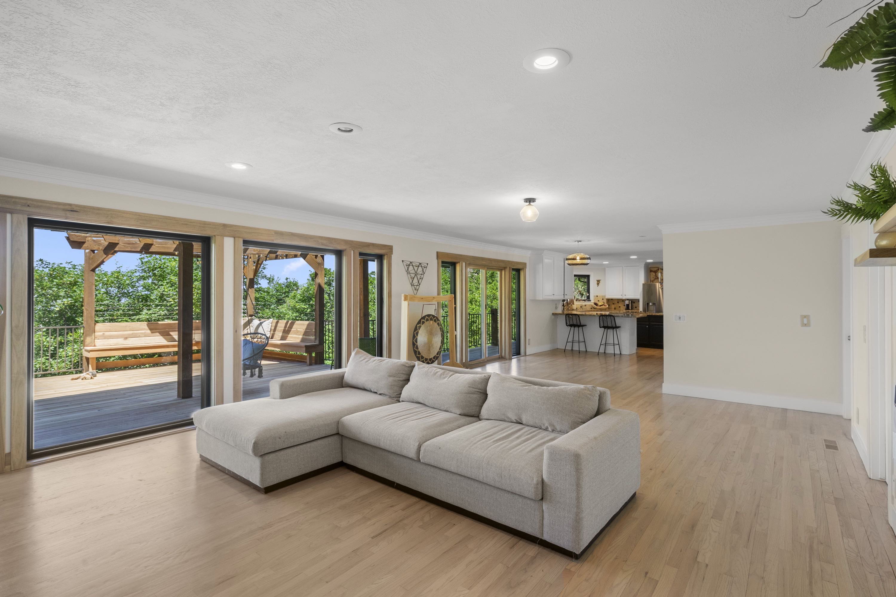 Light wood-finish flooring extends throughout this open-concept living space