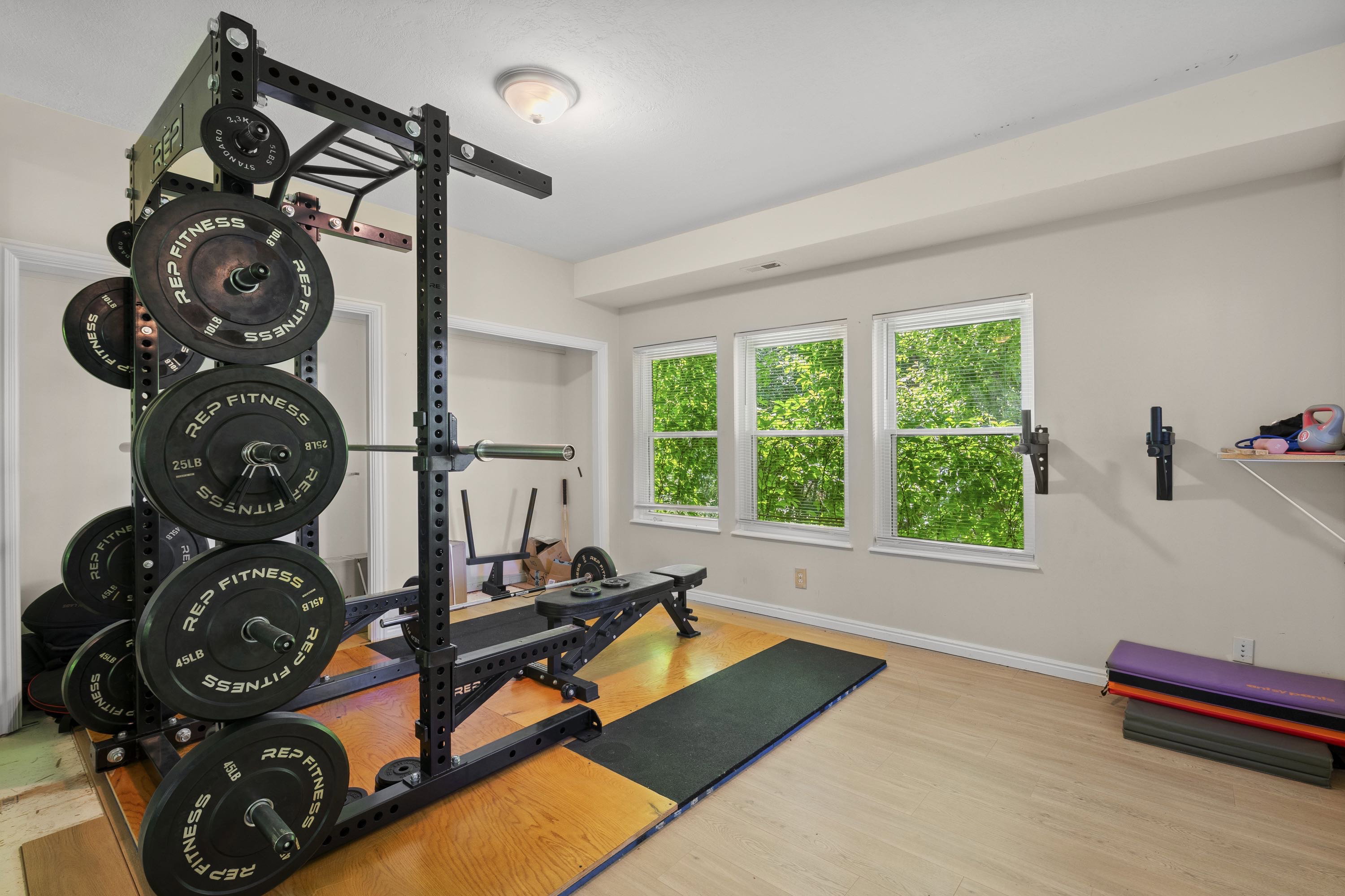 Dedicated room featuring wood-finish flooring and three large windows