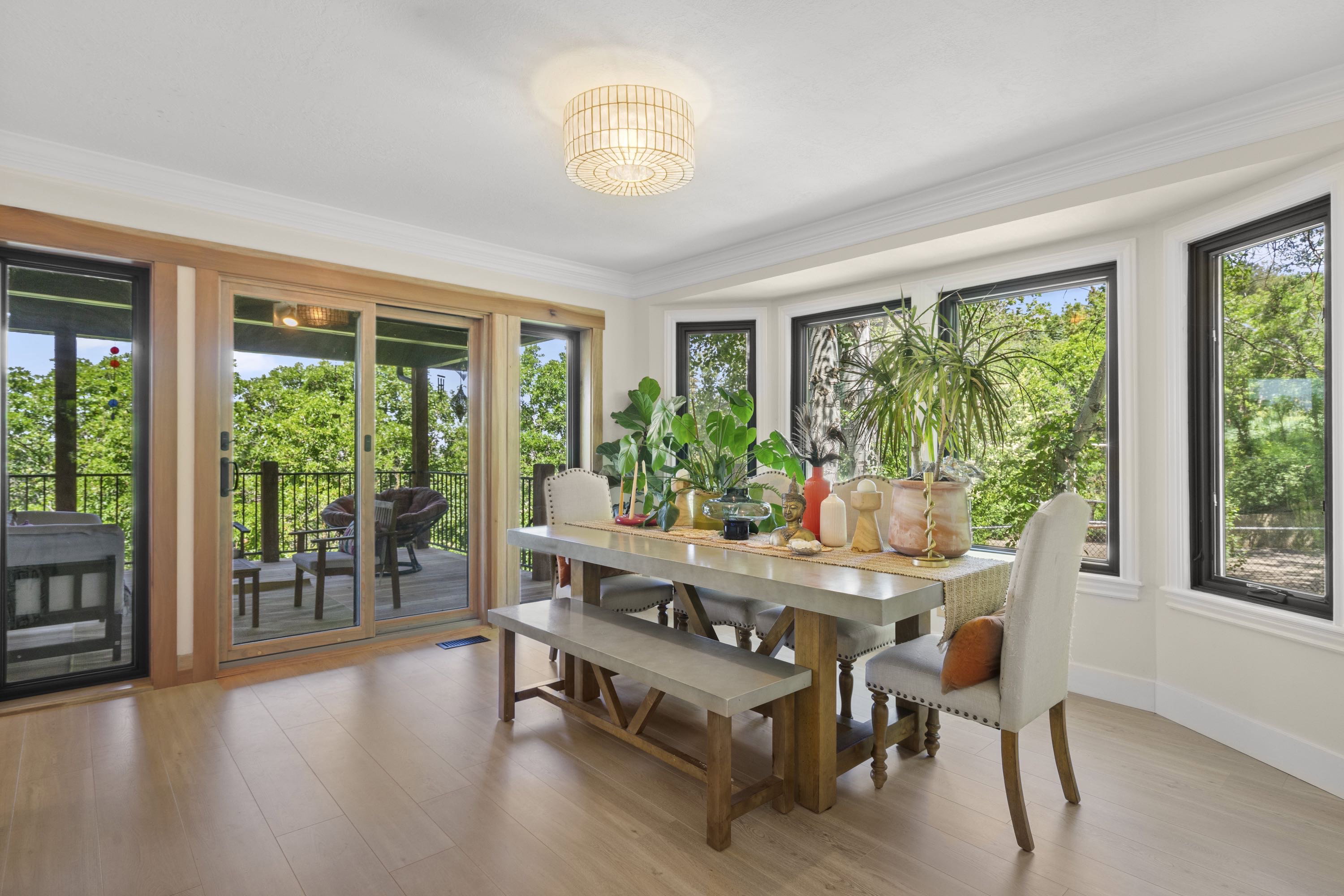 Light wood-finish flooring complements the bay window feature with black trim