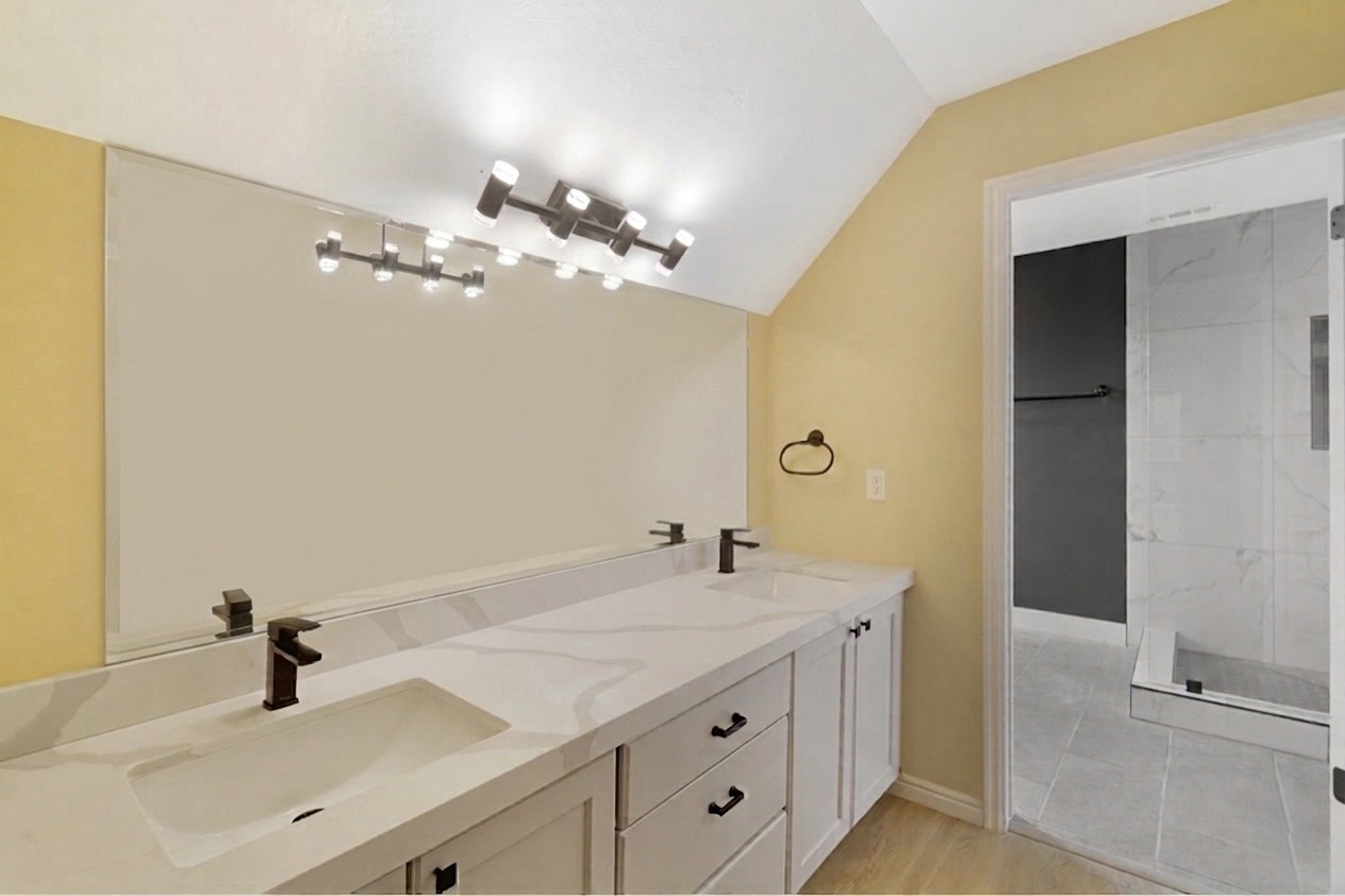 Double vanity with a quartz countertop and integrated rectangular sinks