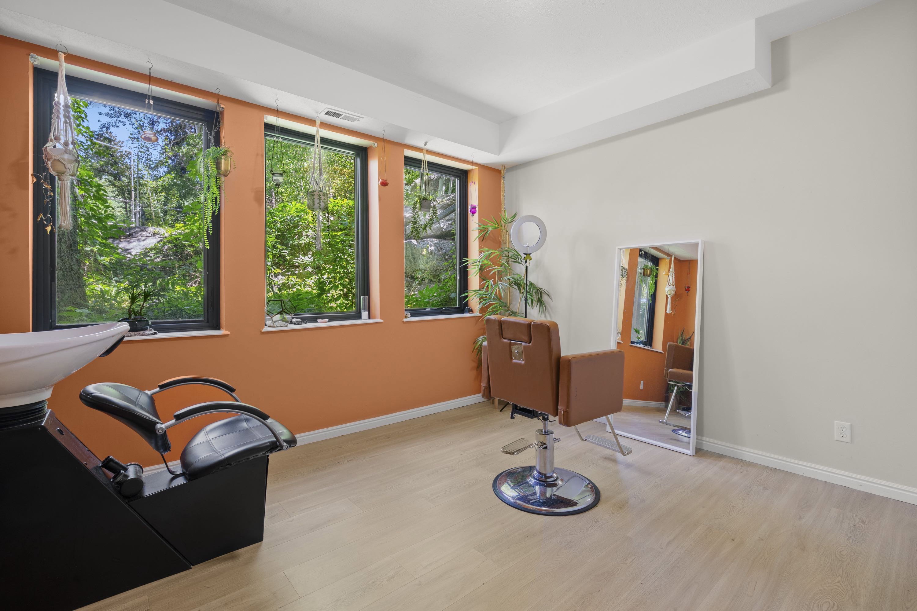 Spacious room featuring multiple large windows with black frames, offering abundant natural light