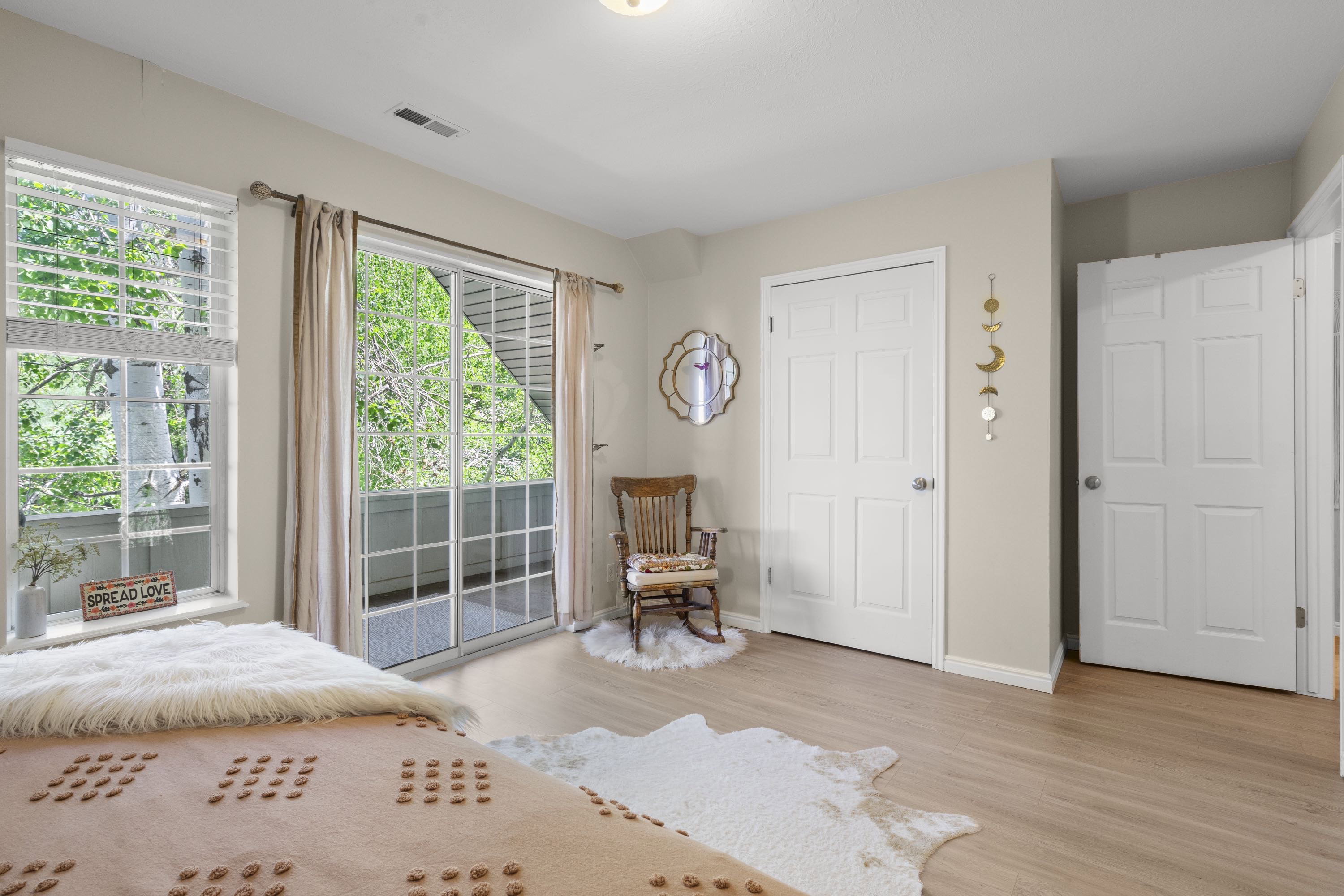 Hardwood-finish flooring throughout, complemented by a sliding glass door to an outdoor balcony