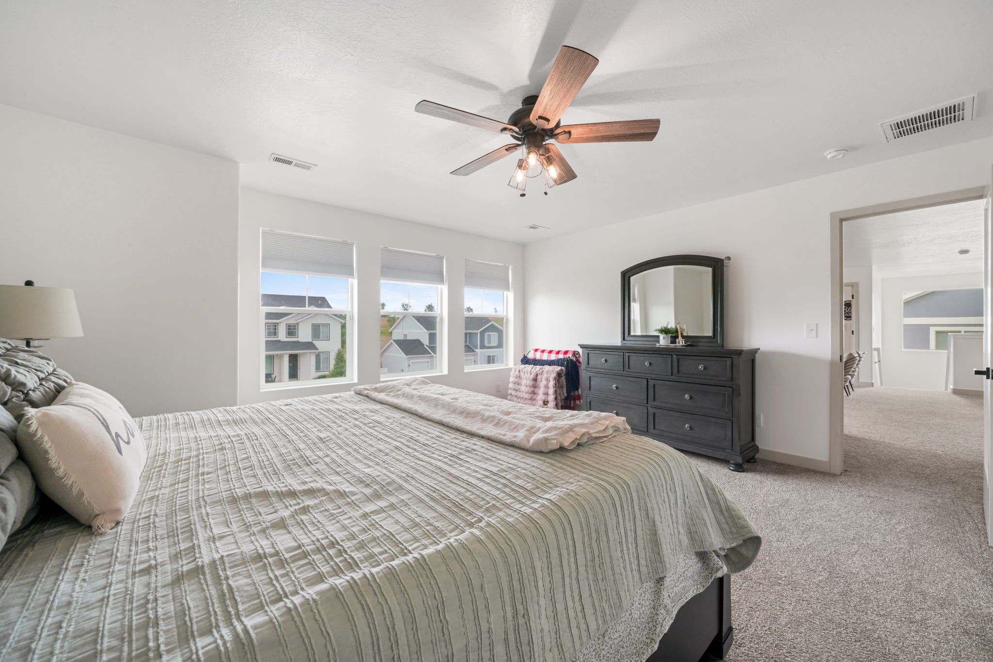 Bedroom featuring plush carpet flooring and a ceiling fan with integrated lighting