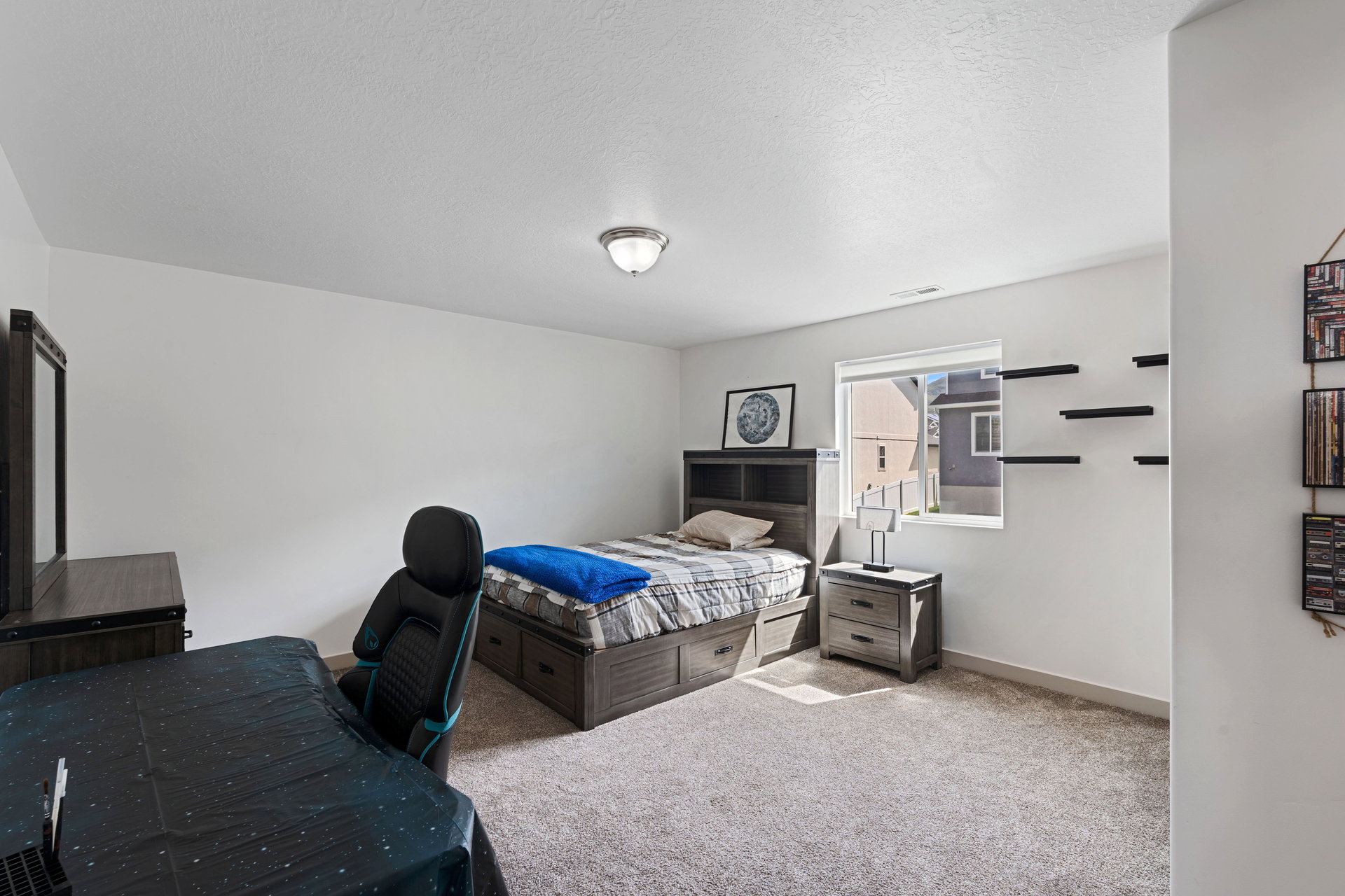 Carpeted interior space featuring white walls and a single window with white trim