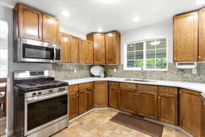 Quartz countertops, gas range, abundant storage space and modern canned lighting