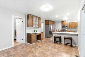 Quartz countertops, newly stained soft close cabinetry, floor to ceiling cabinets for exceptional storage, and a gas range