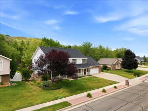 Large lot features dedicated garden areas, full auto sprinkler systems, secondary water, fully fenced, four fruit trees including pear, plum, and two peach trees, mature landscaping