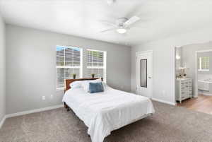 Spacious primary suite with a walk in closet, double vanity, and separate jetted tub and shower