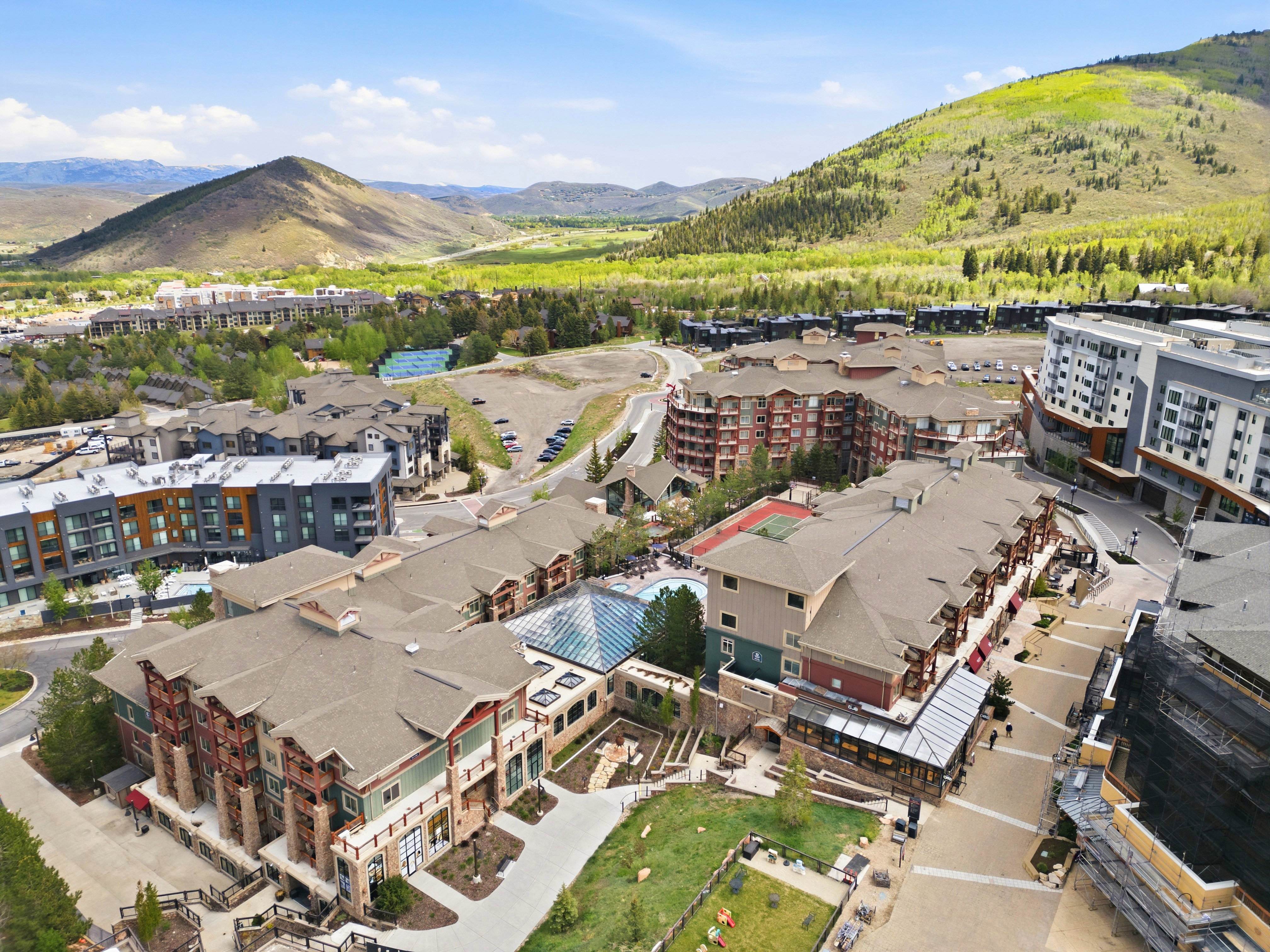 Elevated community featuring multiple multi-story residential buildings and lush green landscapes