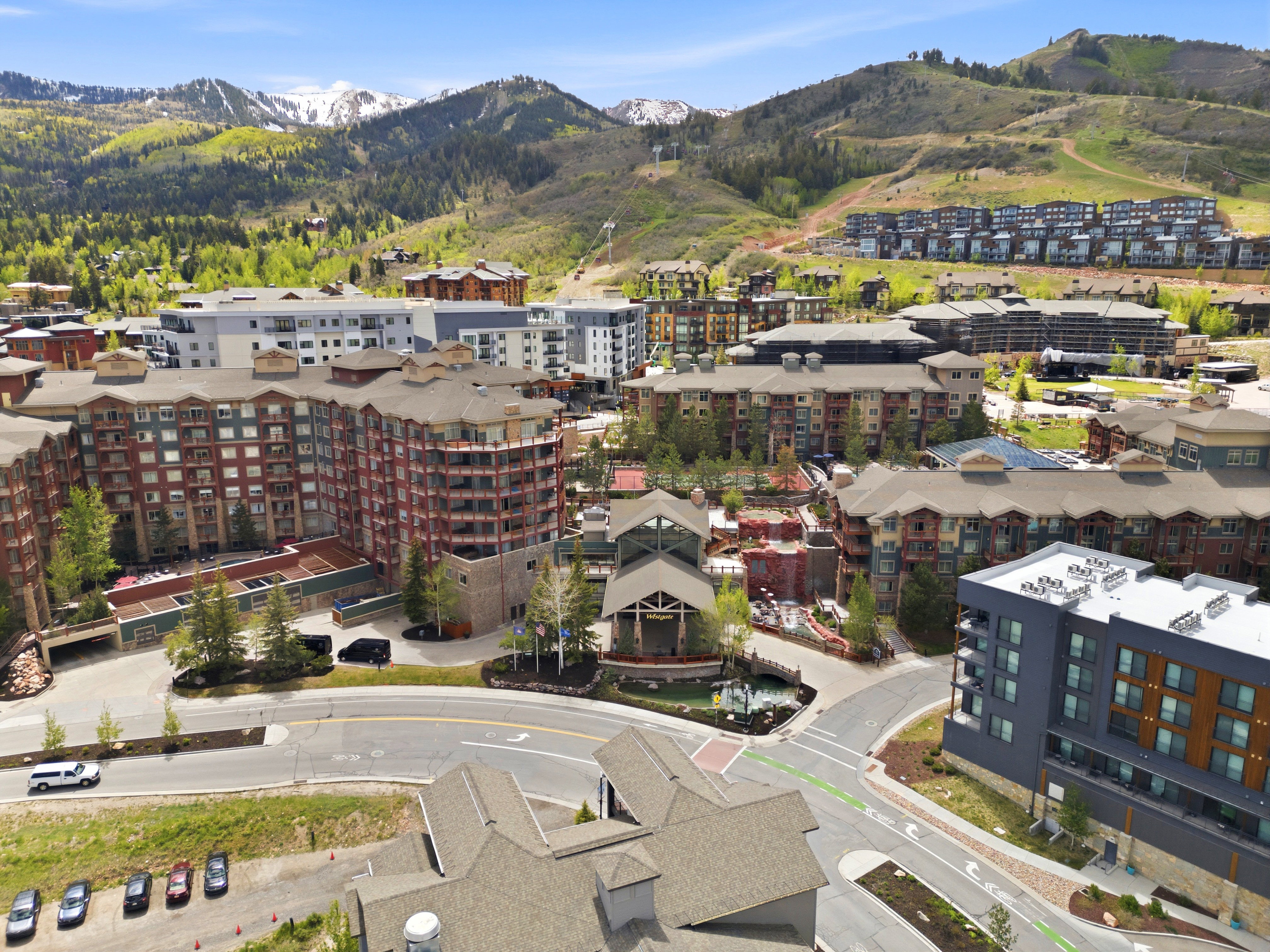 Mountain landscape featuring multiple residential buildings with varied architectural styles and surrounding roads