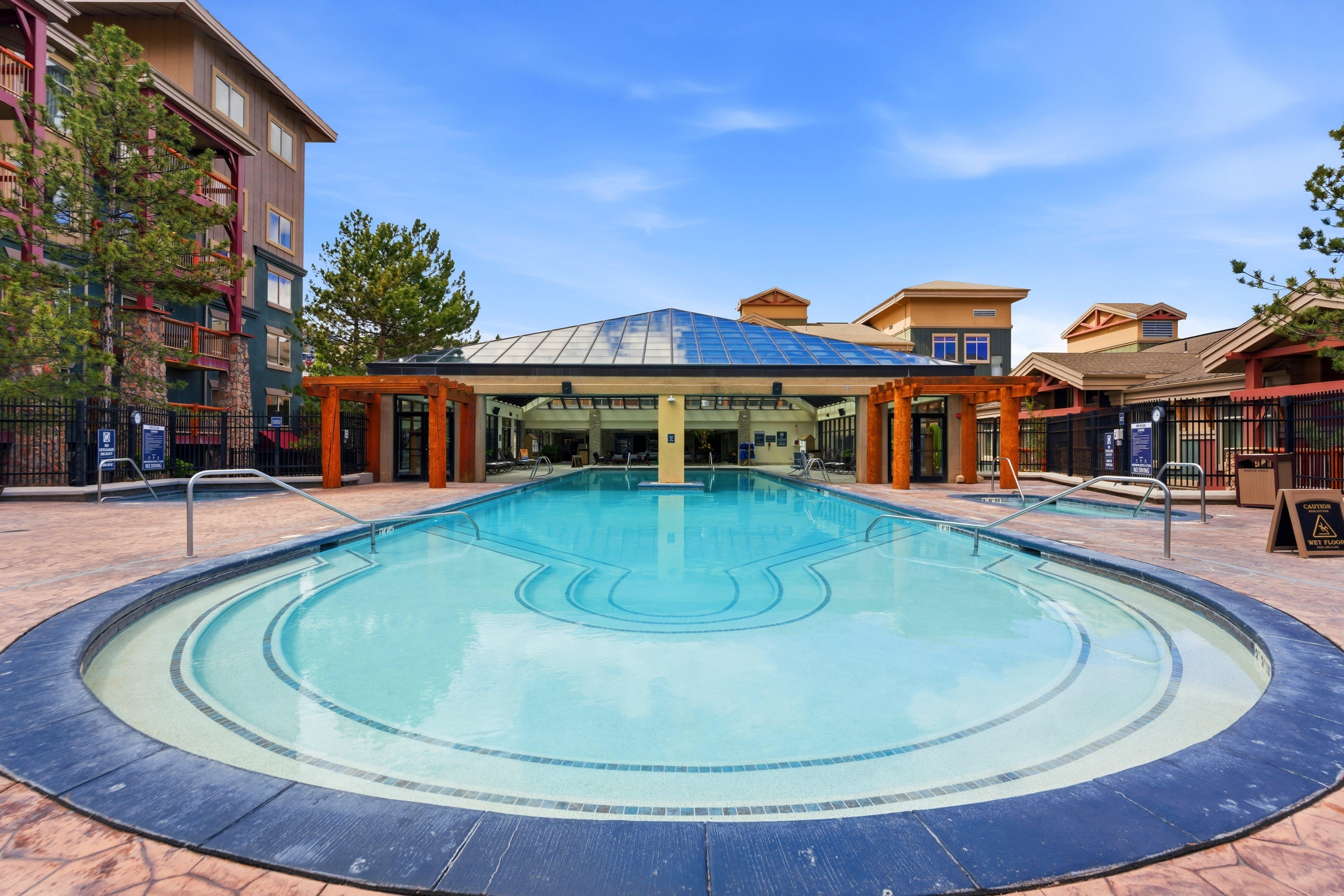 Resort-style pool with integrated spa and decorative tile accents