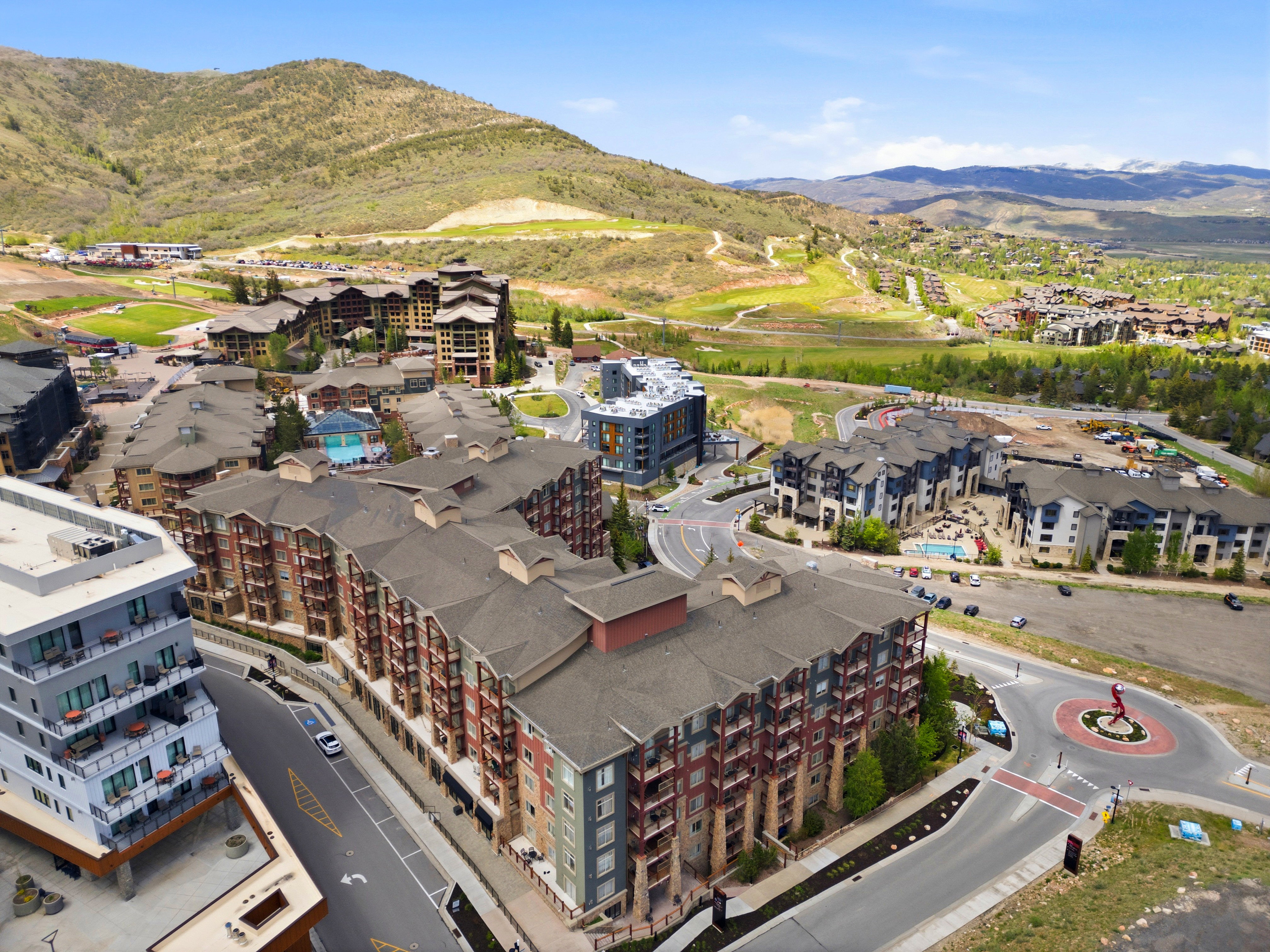 Multi-story residential buildings featuring varied architectural styles and exterior finishes, including stone, wood, and paneling