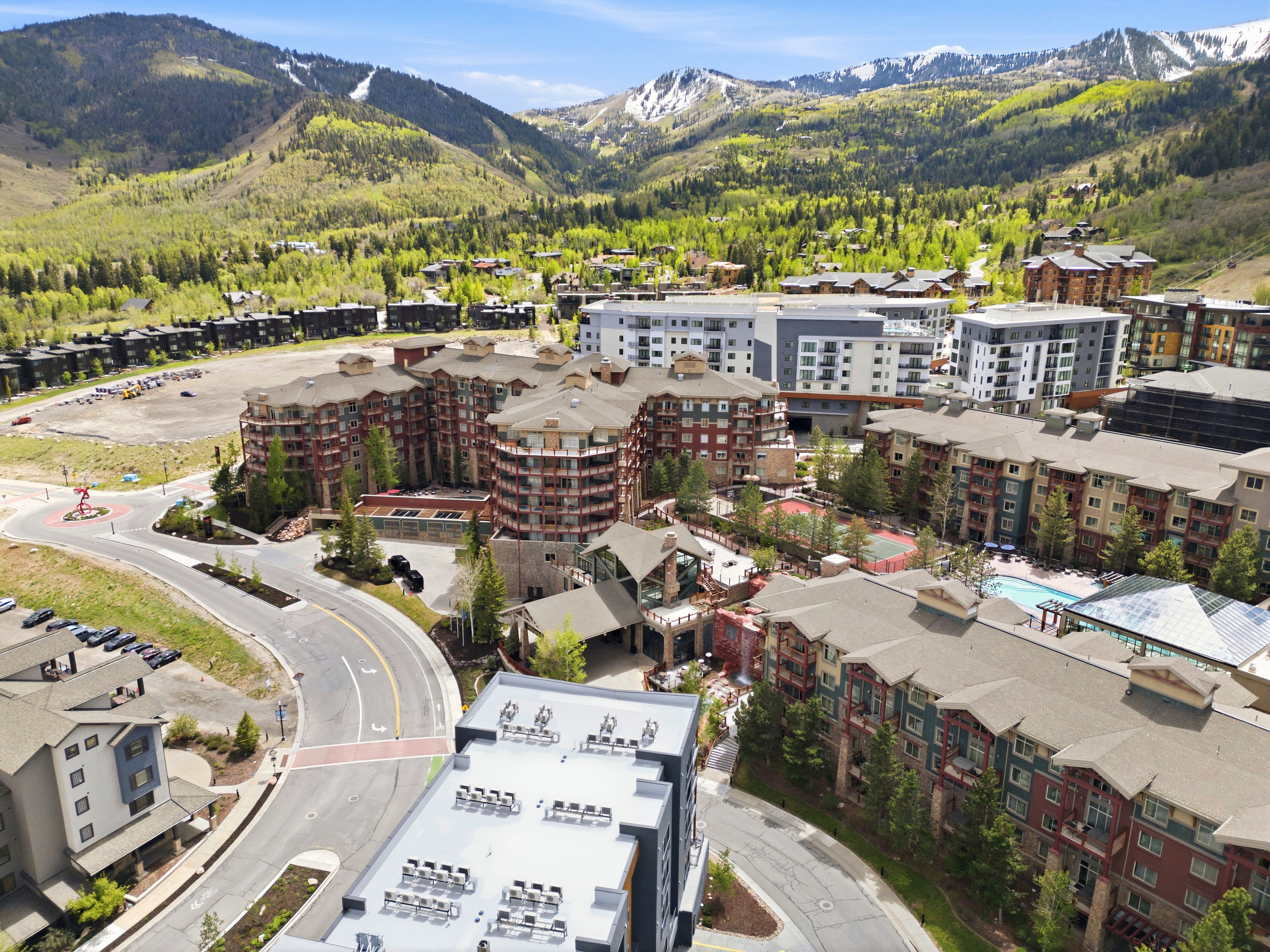 Aerial perspective showcasing a vibrant community nestled within a mountainous landscape