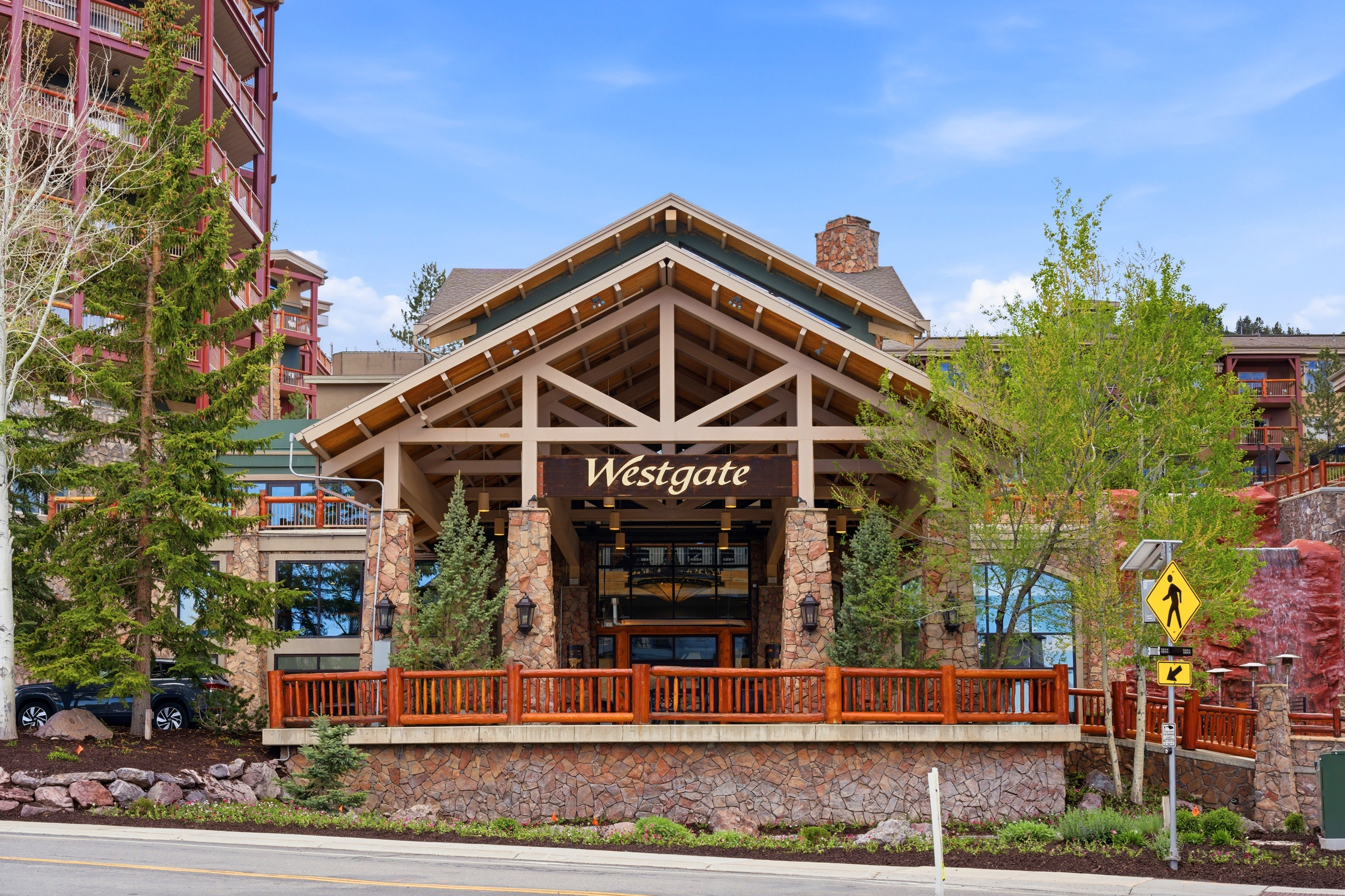 Stone and timber lodge-style architecture with a prominent porte-cochère