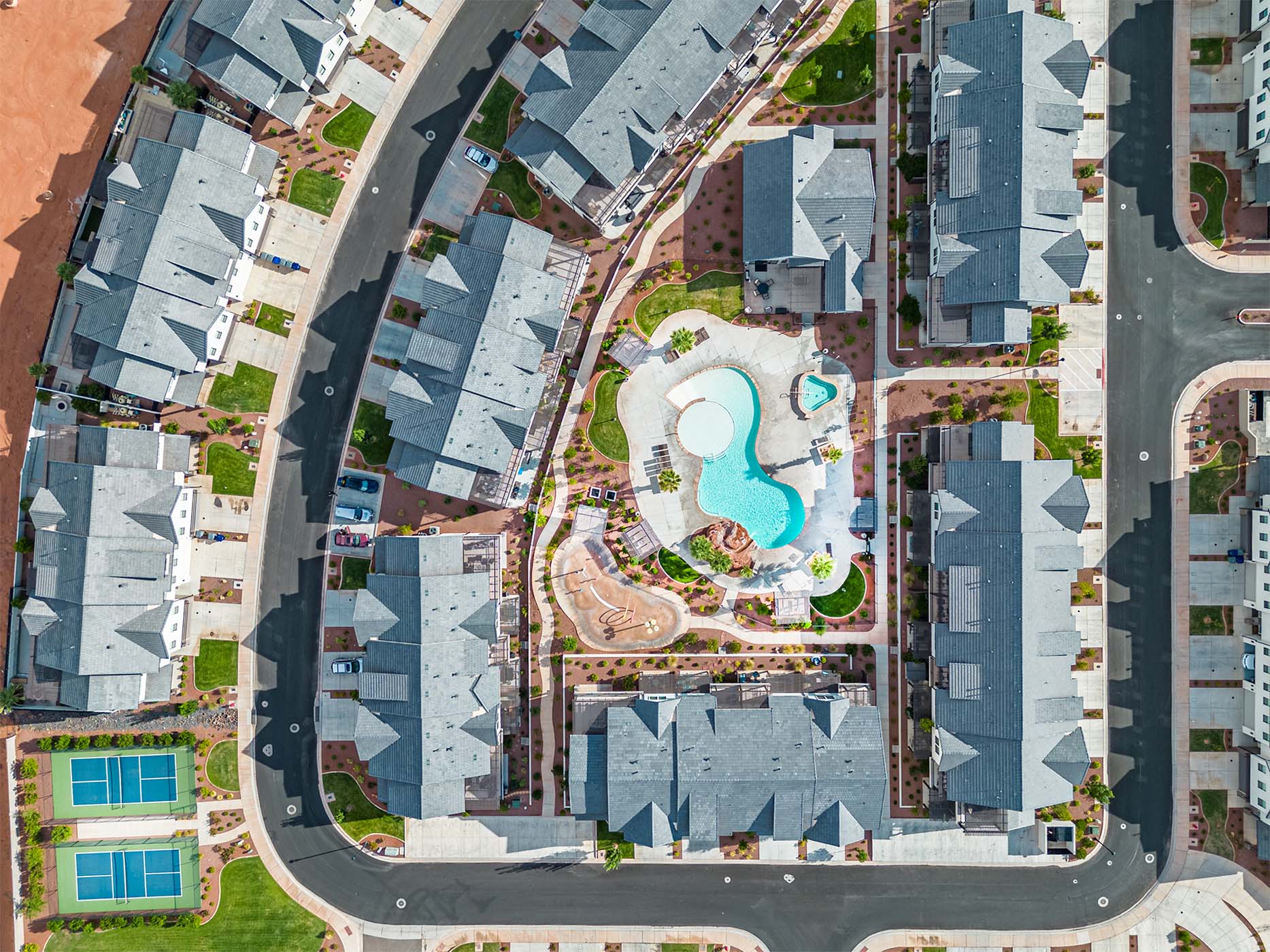 Community amenities featuring a resort-style pool with a separate hot tub, surrounding lounge areas, and a children's play structure