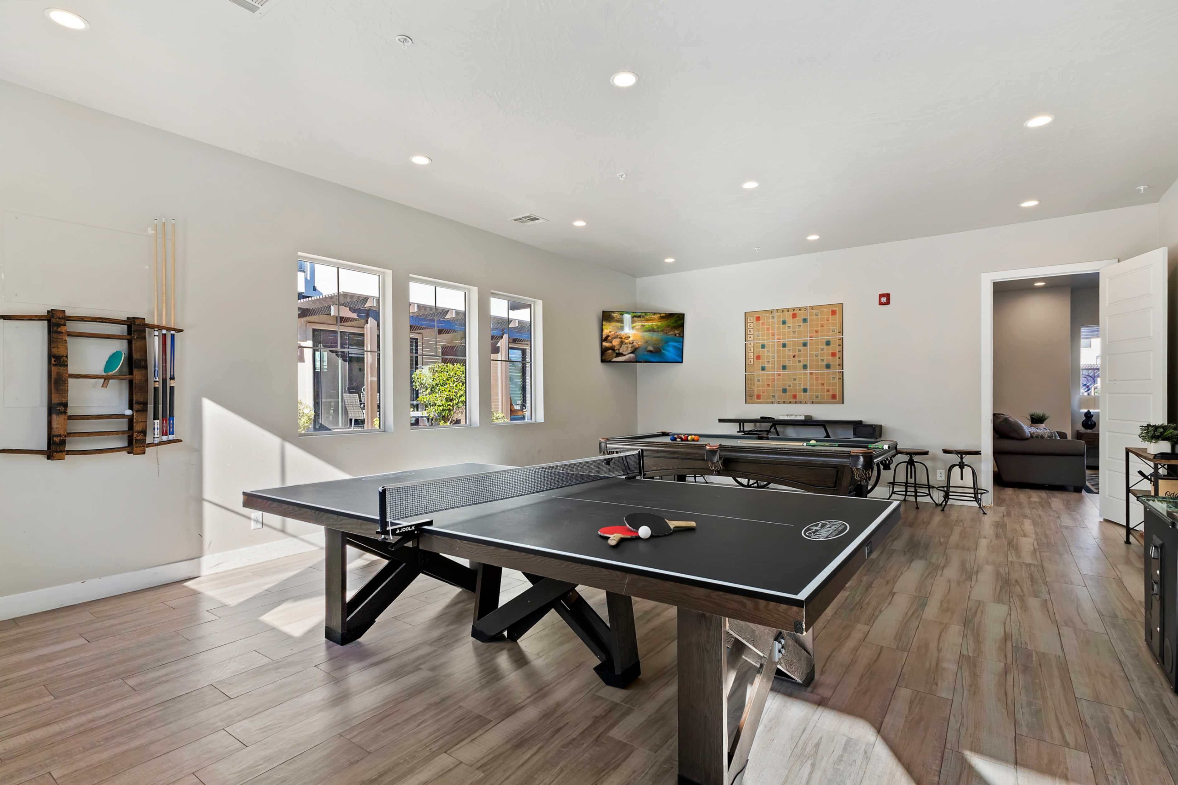 Recreational space featuring wood-finish flooring and recessed lighting