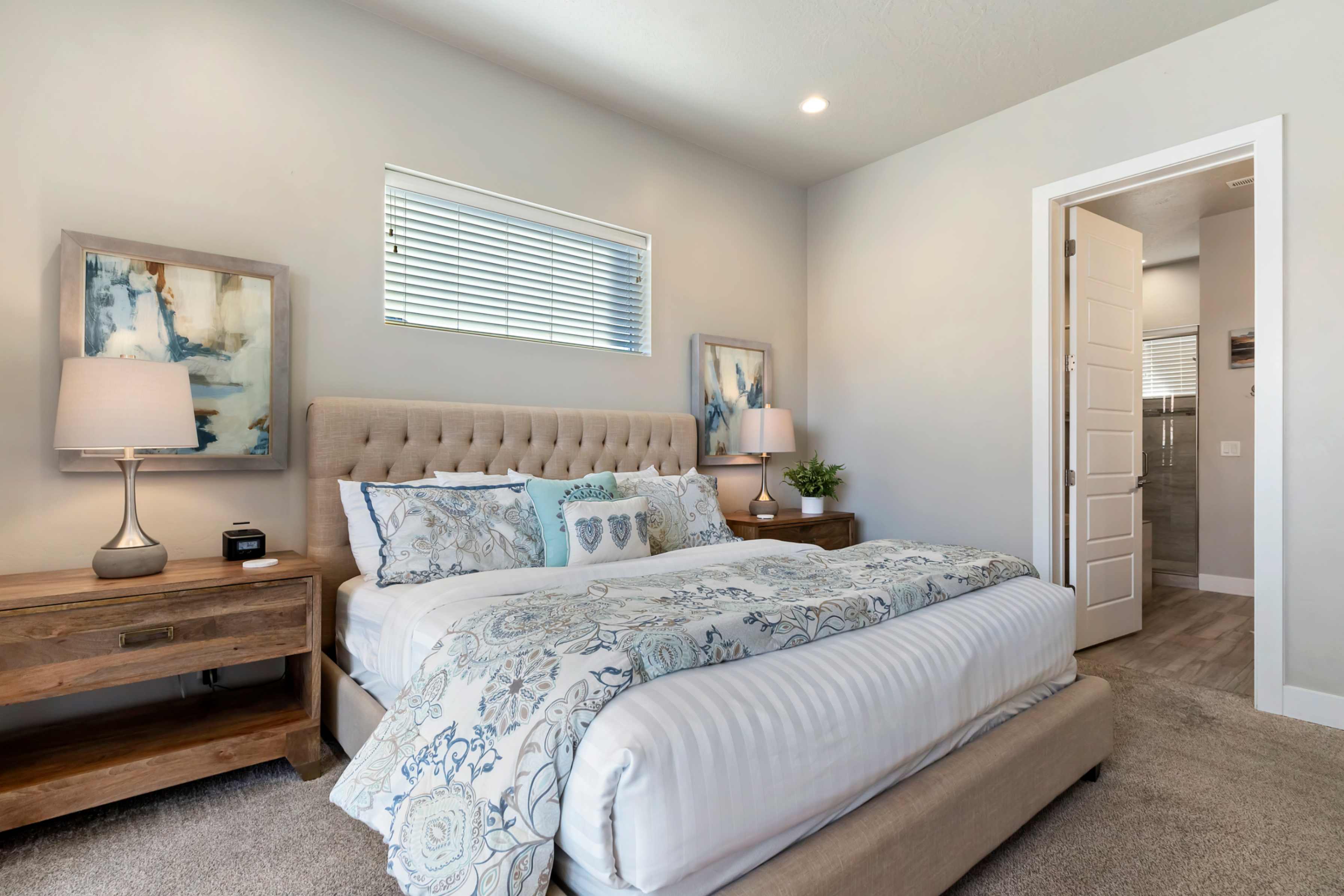 Carpeted bedroom featuring a low-profile window with blinds, recessed lighting, and a neutral color palette
