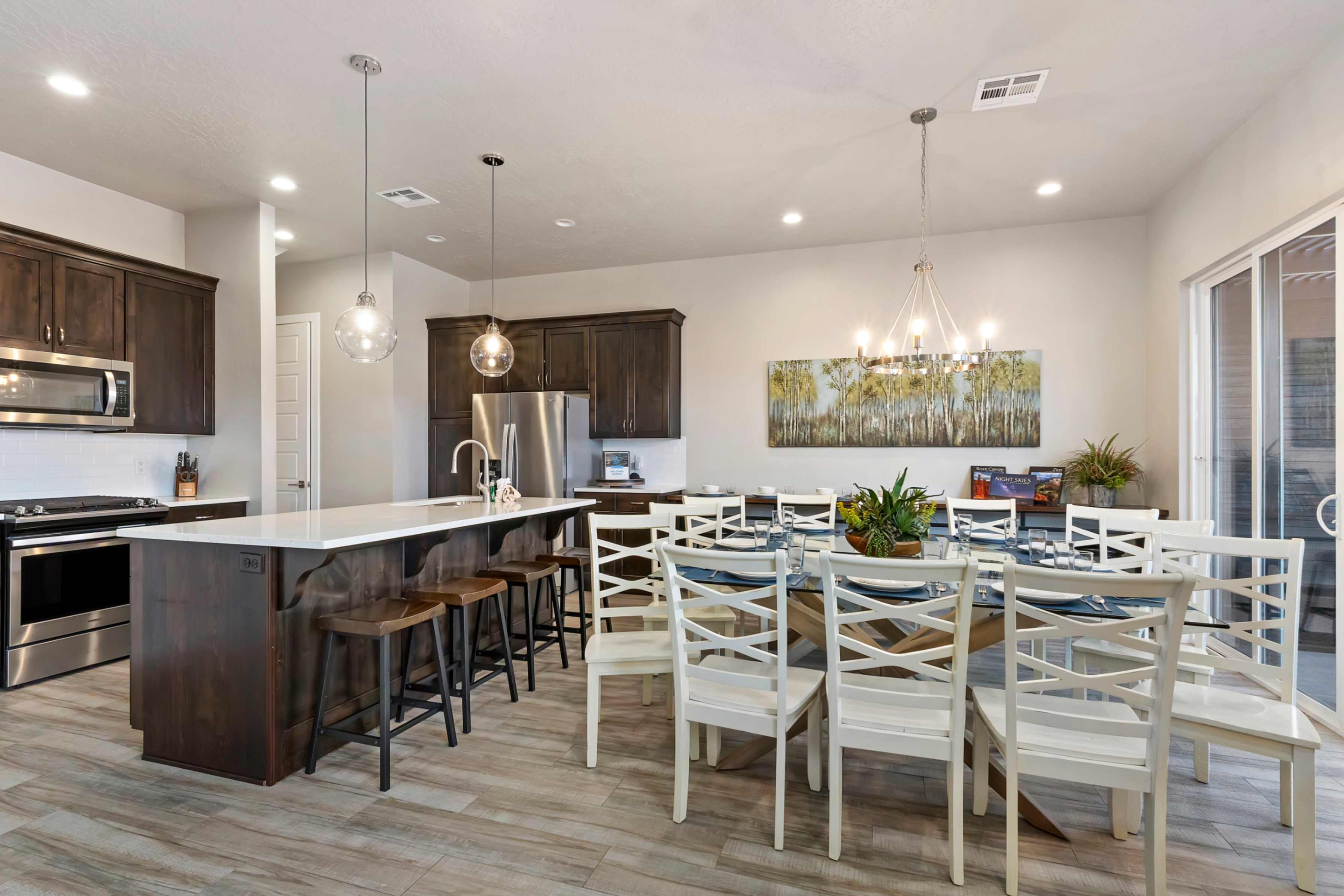 Open-concept kitchen and dining area featuring wood-finish flooring