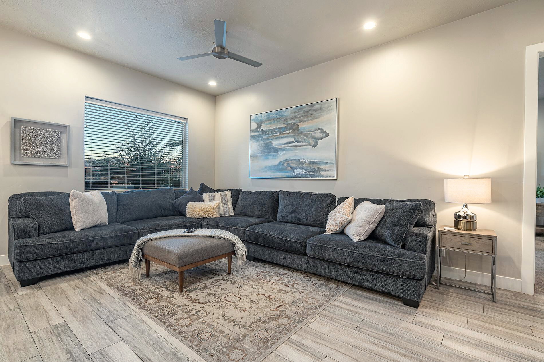 Living area featuring light wood-finish flooring, recessed lighting, and a ceiling fan