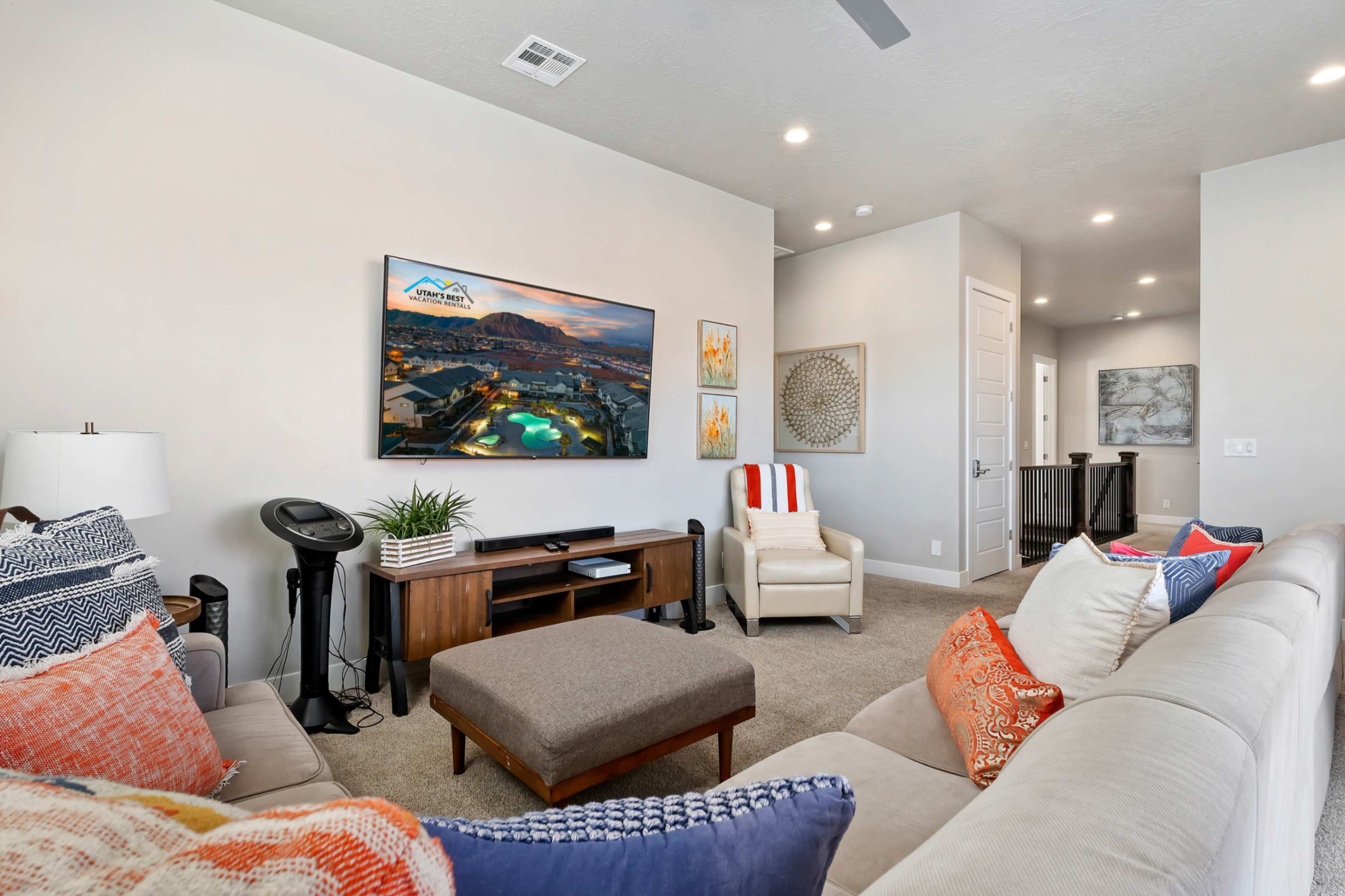 Carpeted living area featuring recessed lighting, a ceiling fan, and a wall-mounted flat-screen television