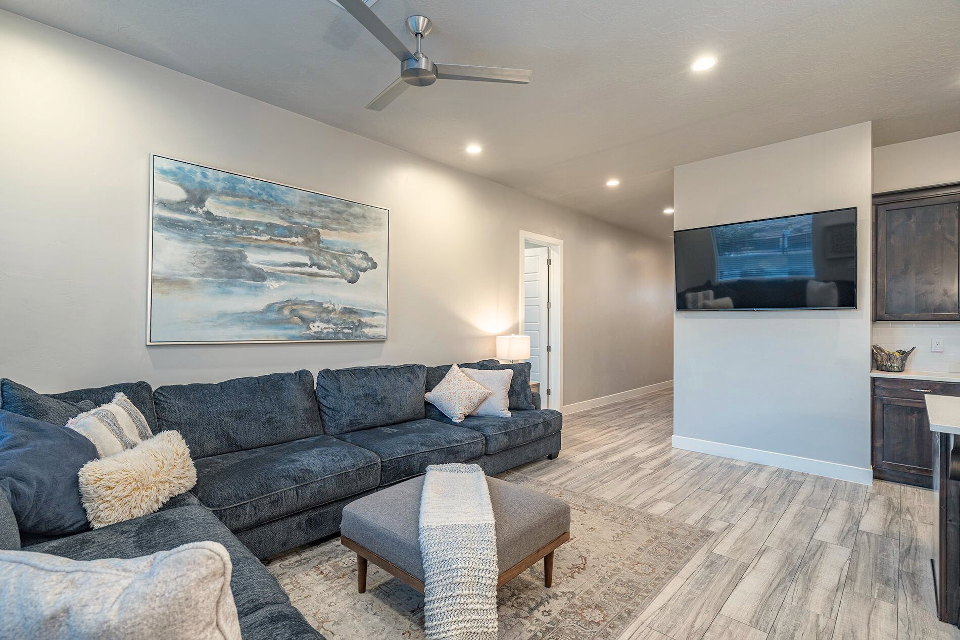 Living area featuring recessed lighting, a ceiling fan, and wood-finish flooring