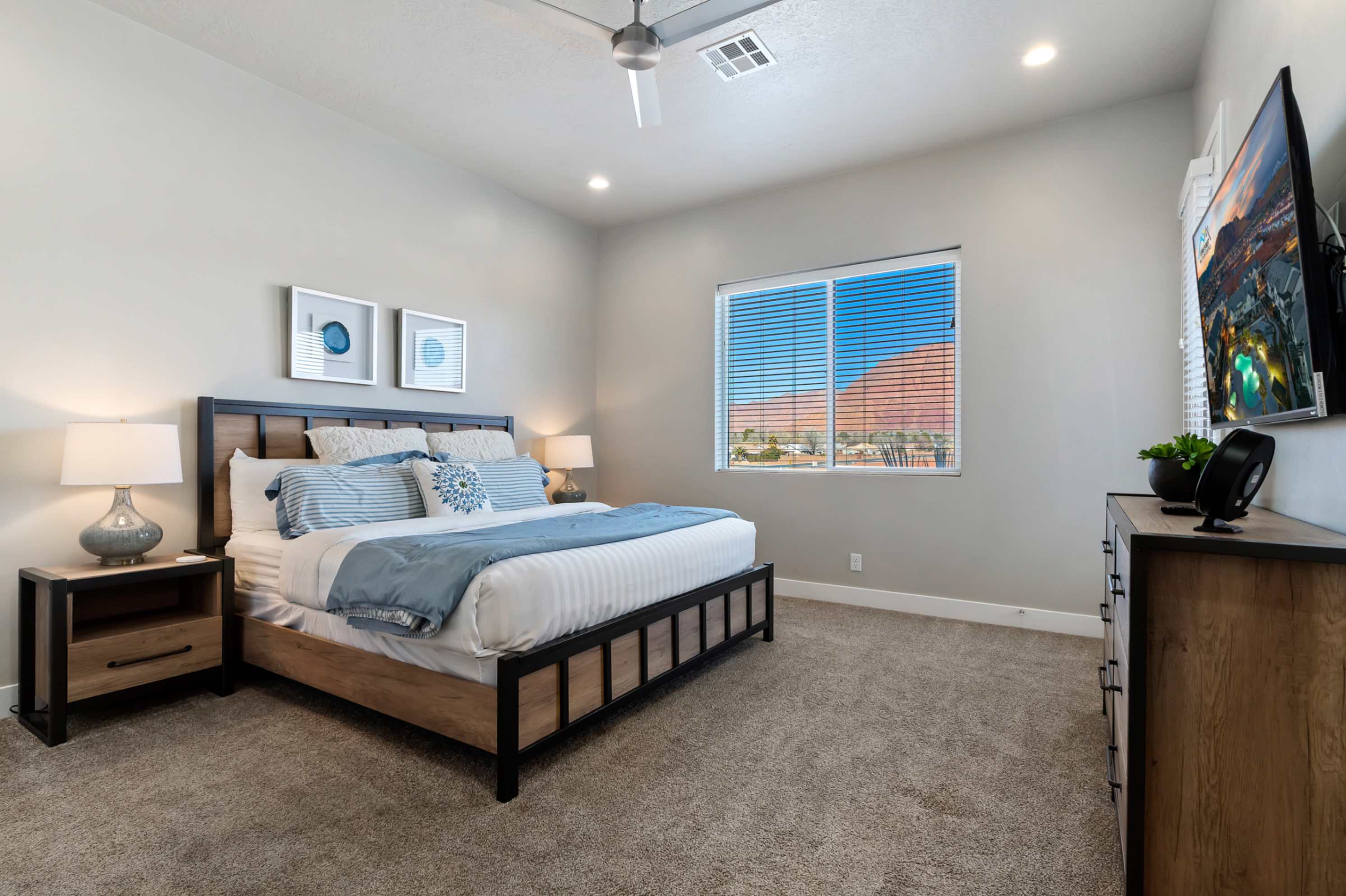 Bedroom featuring a ceiling fan, recessed lighting, and a large window with horizontal blinds