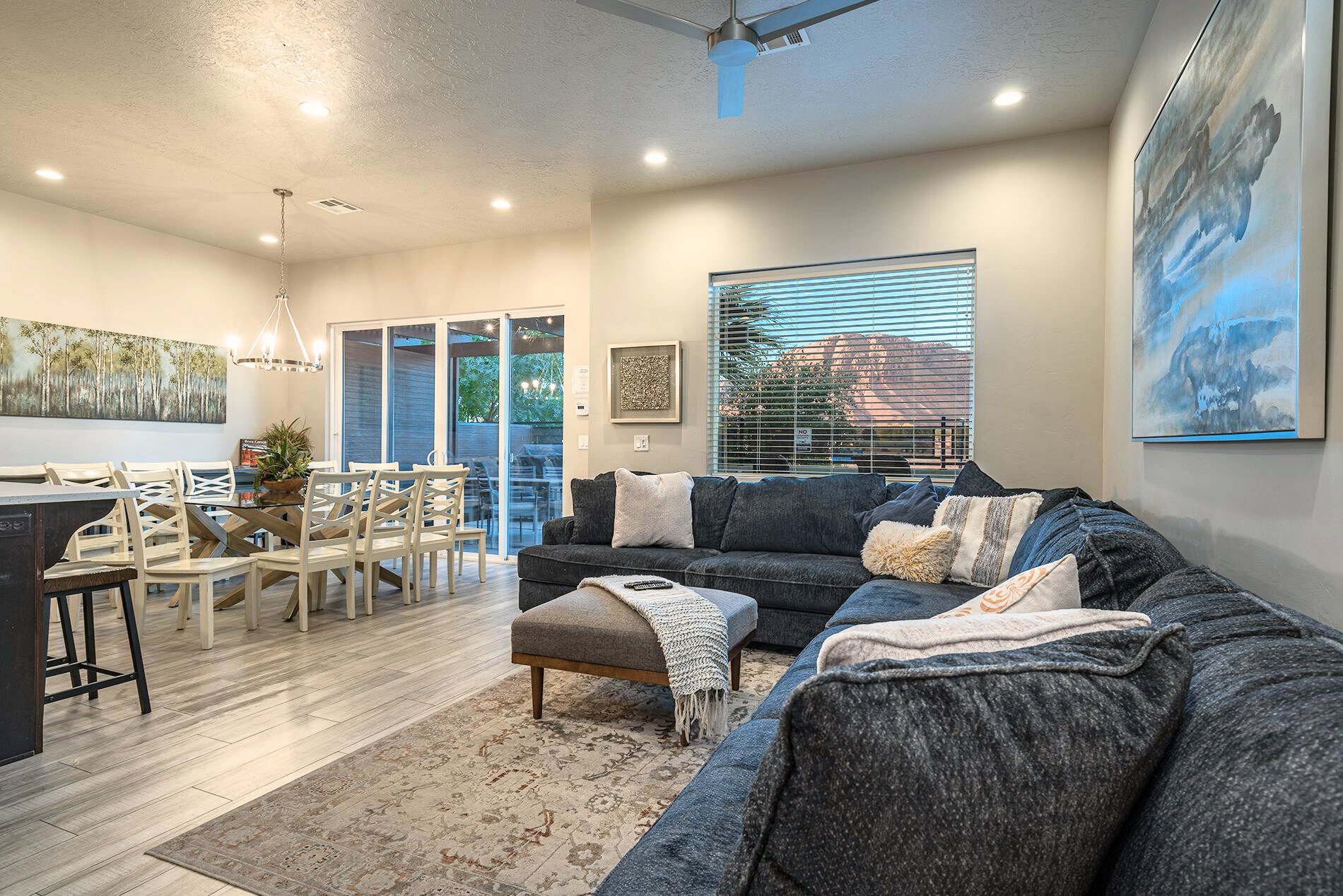 Open-concept living space featuring wood-finish flooring, recessed lighting, and a modern ceiling fan