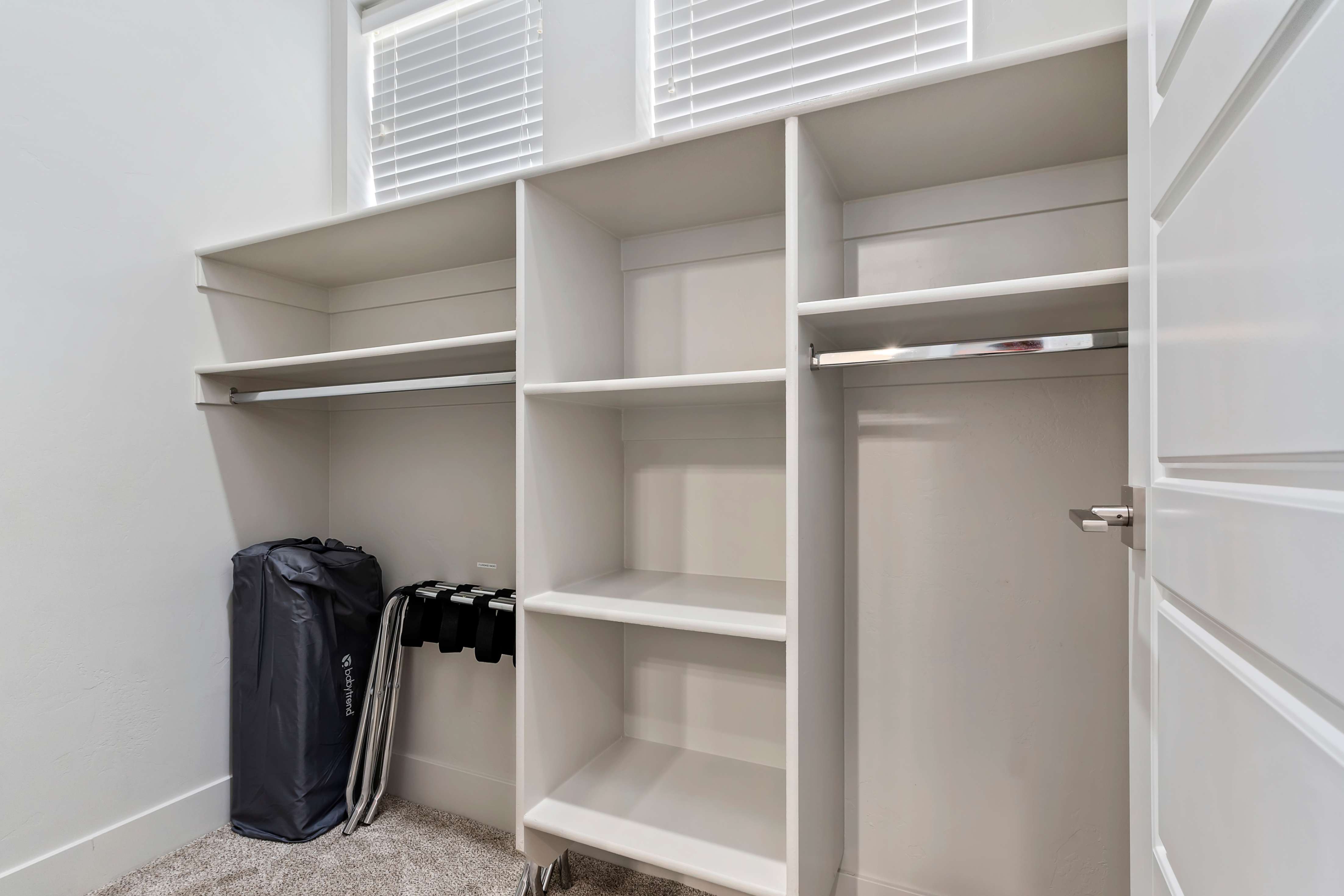 Custom closet system featuring multiple shelving units and hanging rods
