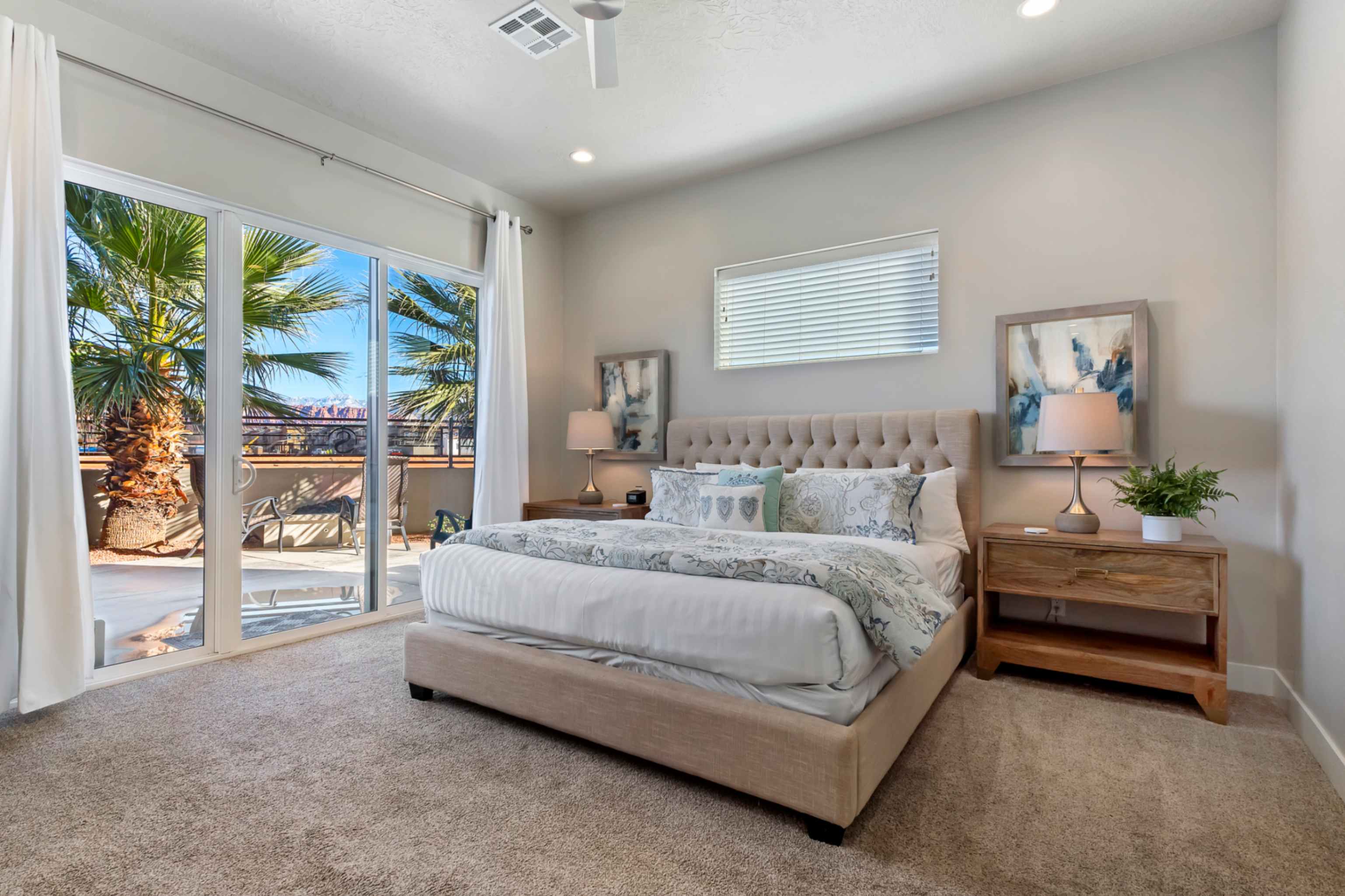 Sliding glass doors opening to an exterior patio with metal railing