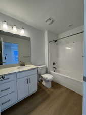 Bathroom with white vanity, integrated sink, and light countertop