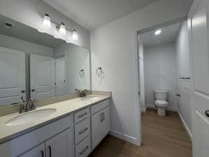 Bathroom featuring a double vanity with light-toned countertops and undermount sinks