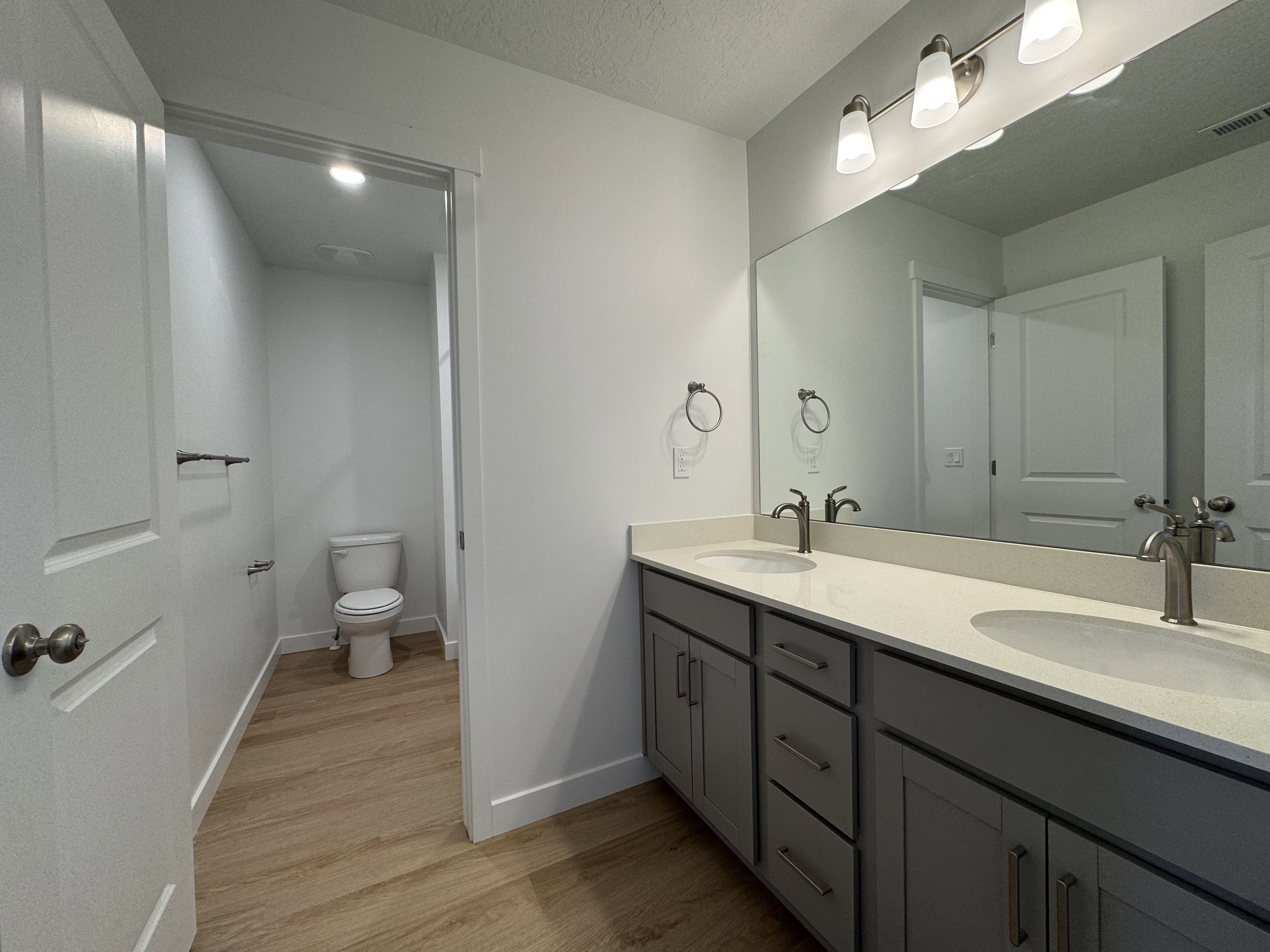 Dual vanity with brushed nickel fixtures and light-toned countertop