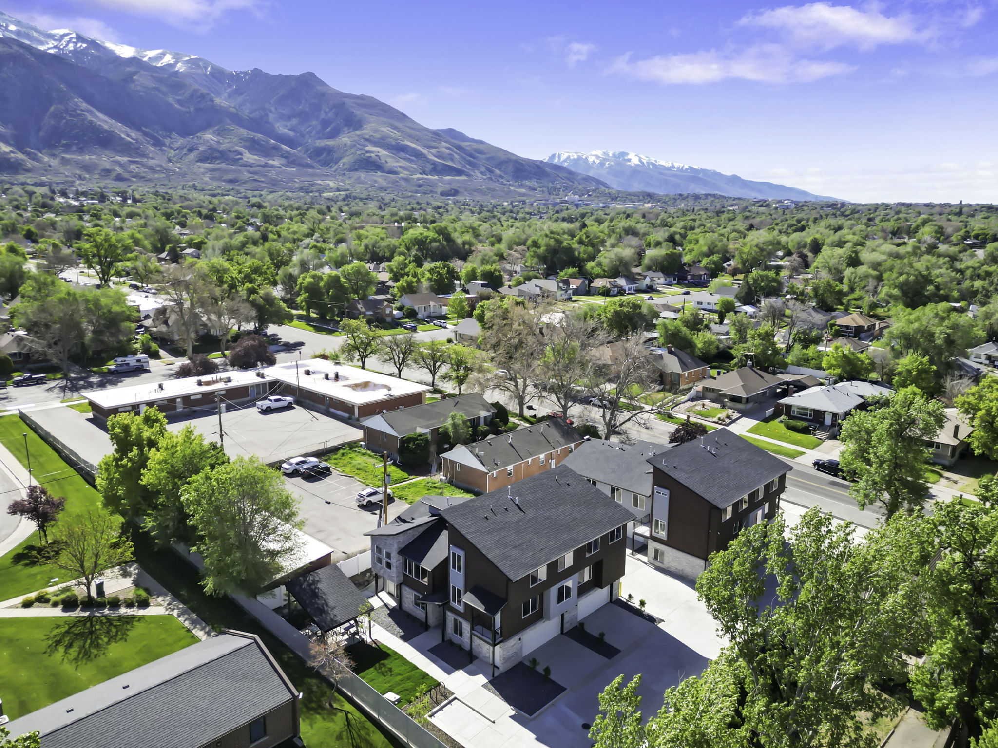 Modern townhome development featuring multi-level units with dark siding and light accents