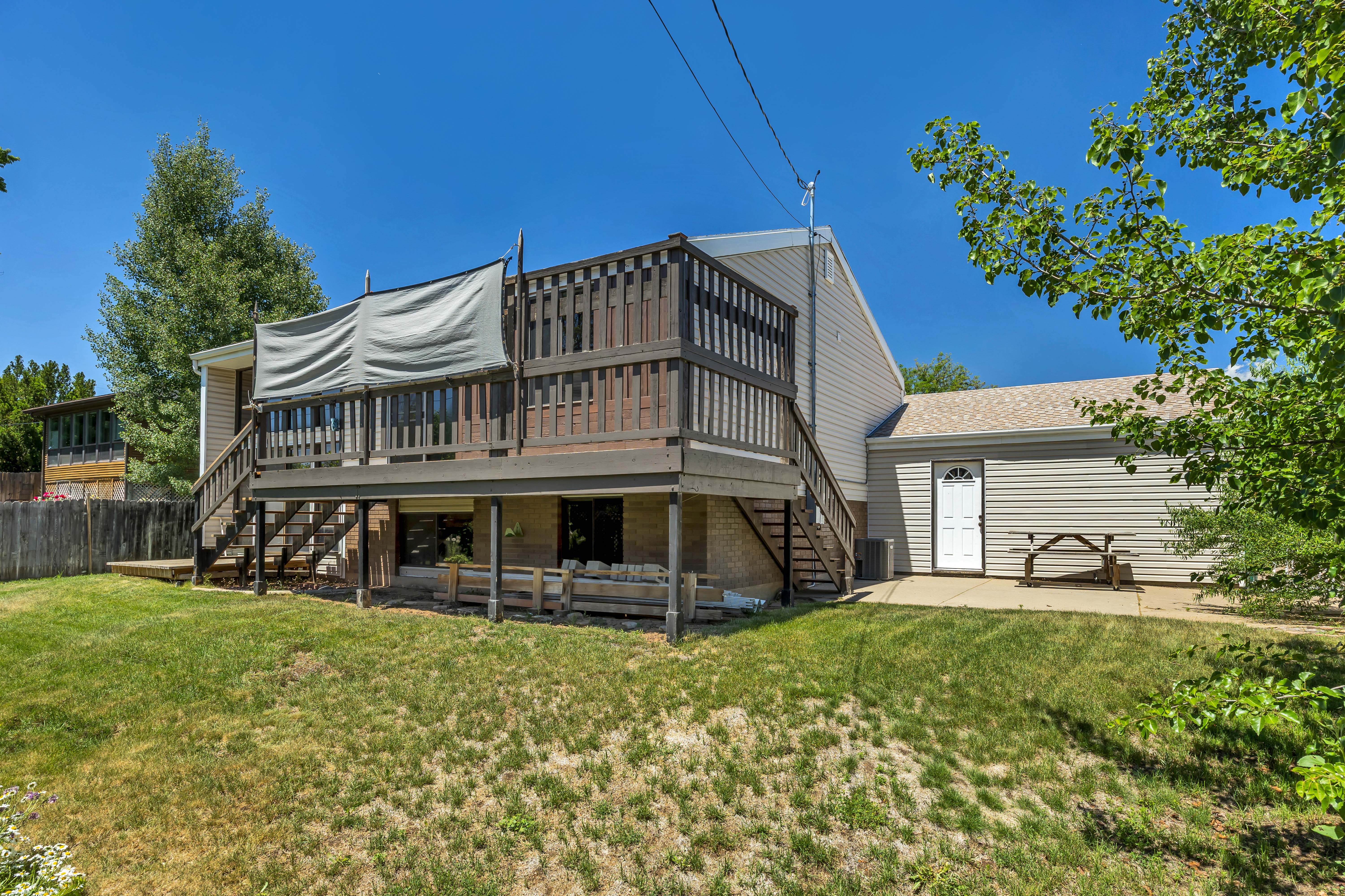 Multi-level rear decking with dark wood railings and stairs