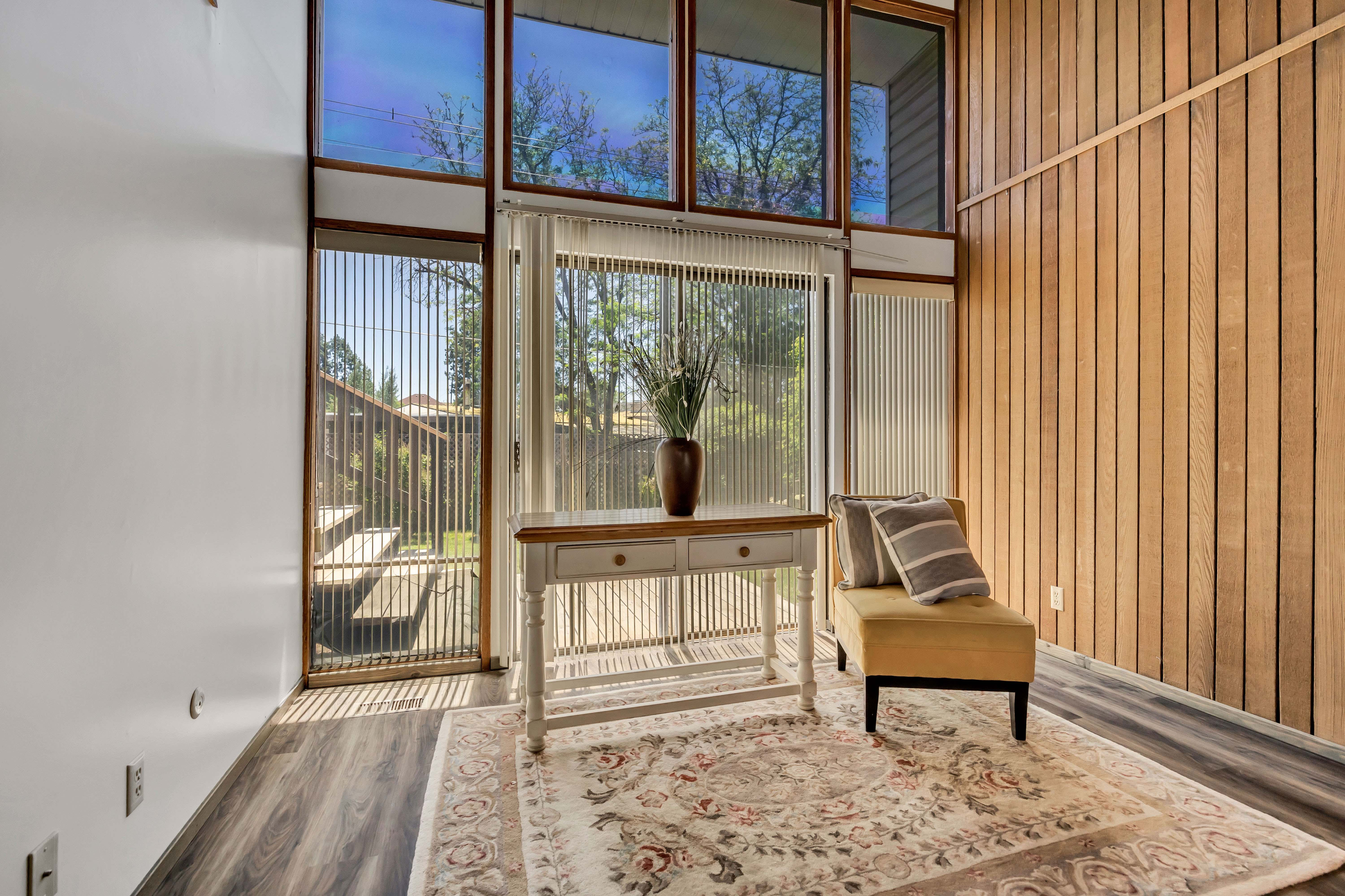 Floor-to-ceiling windows with vertical blinds