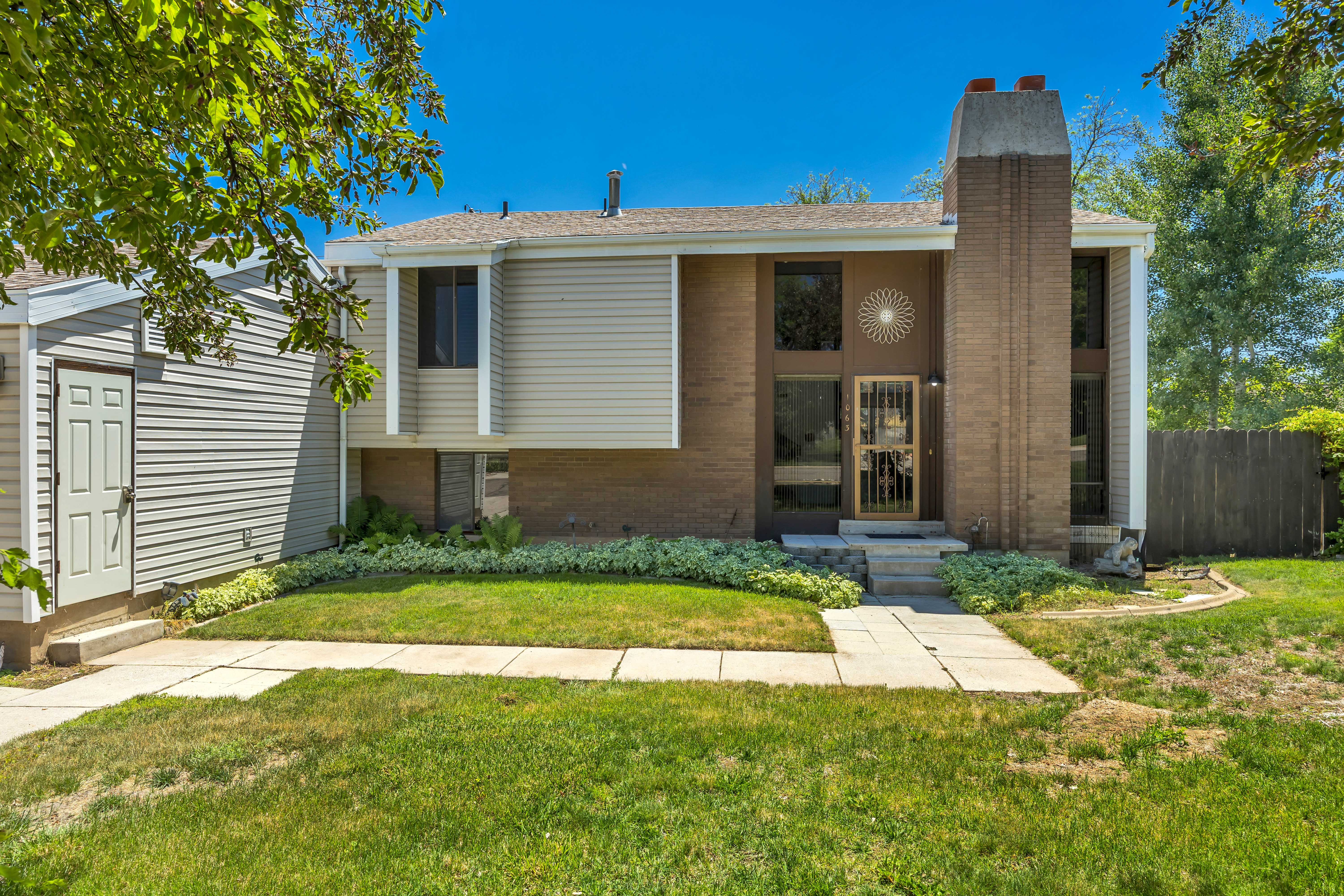 Brick and siding exterior with a prominent brick chimney feature