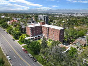 Brick multi-story building featuring multiple windows and a flat roof