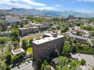 Expansive aerial perspective showcasing a multi-story brick building with a flat roof