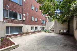 Brick exterior with multiple windows and concrete foundation